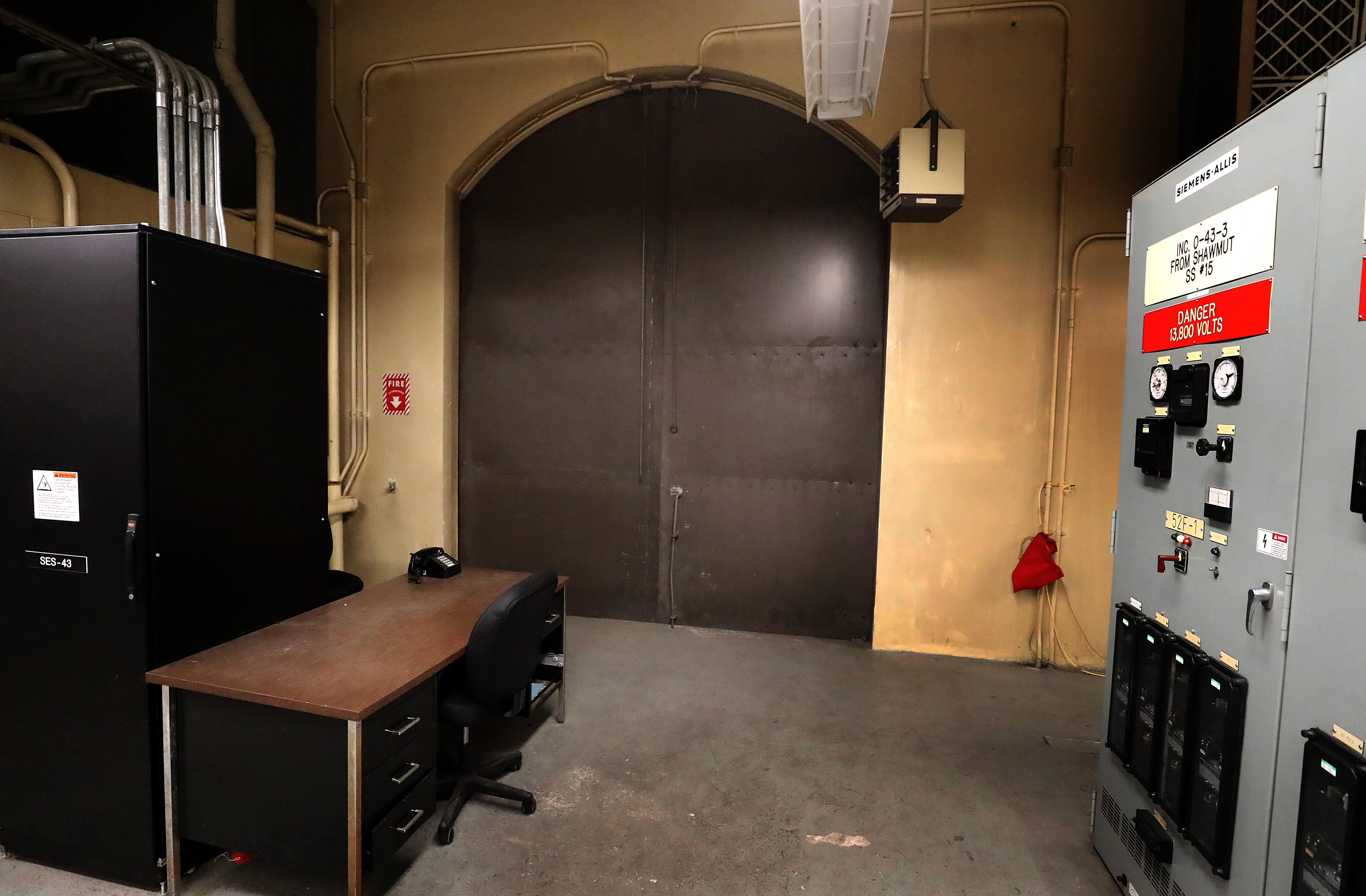 The top of the door, on the second floor, is framed by electrical equipment.