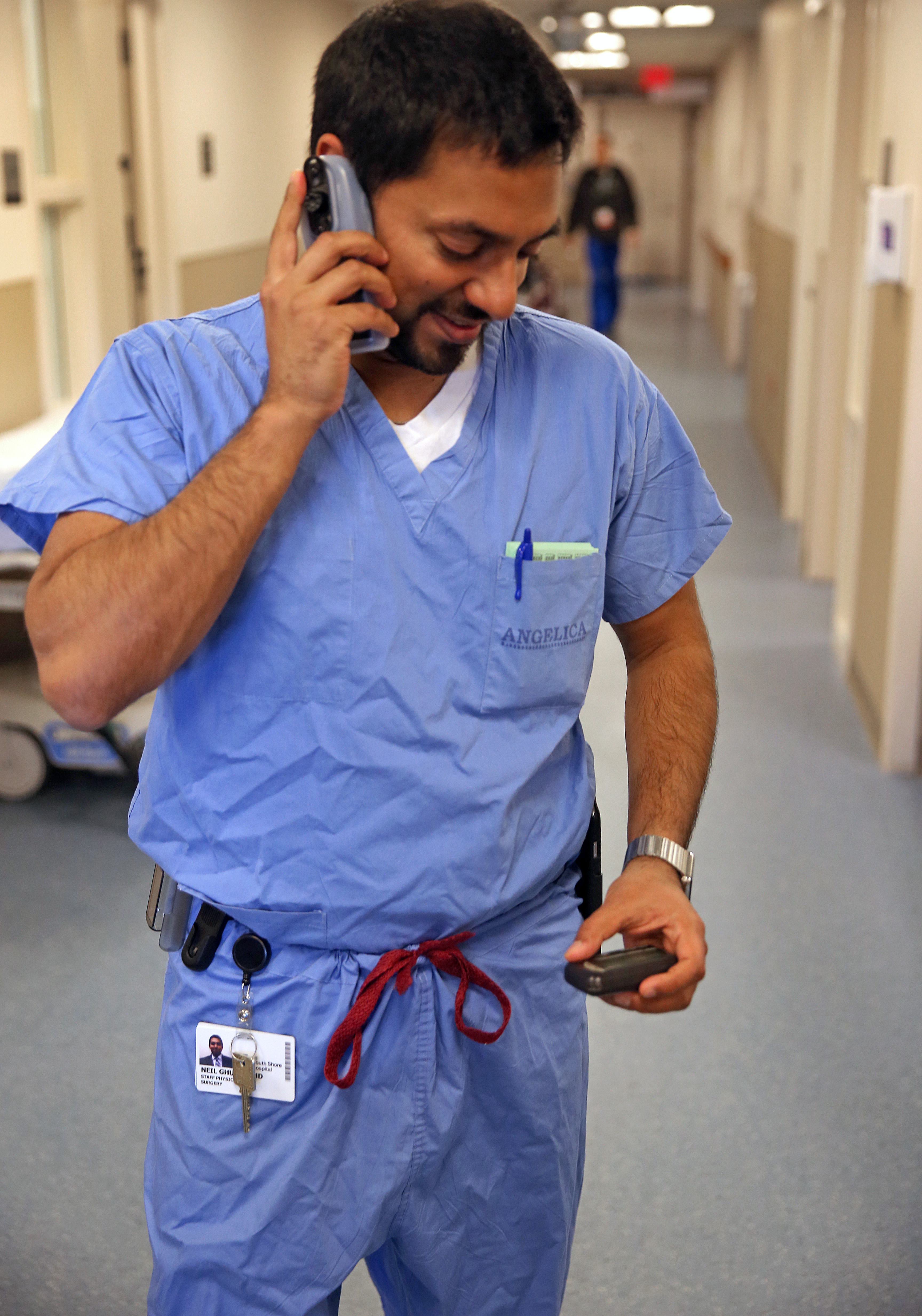 Dr. Neil Ghushe of South Shore Hospital may utilize his cellphone, but he also still uses a pager.
