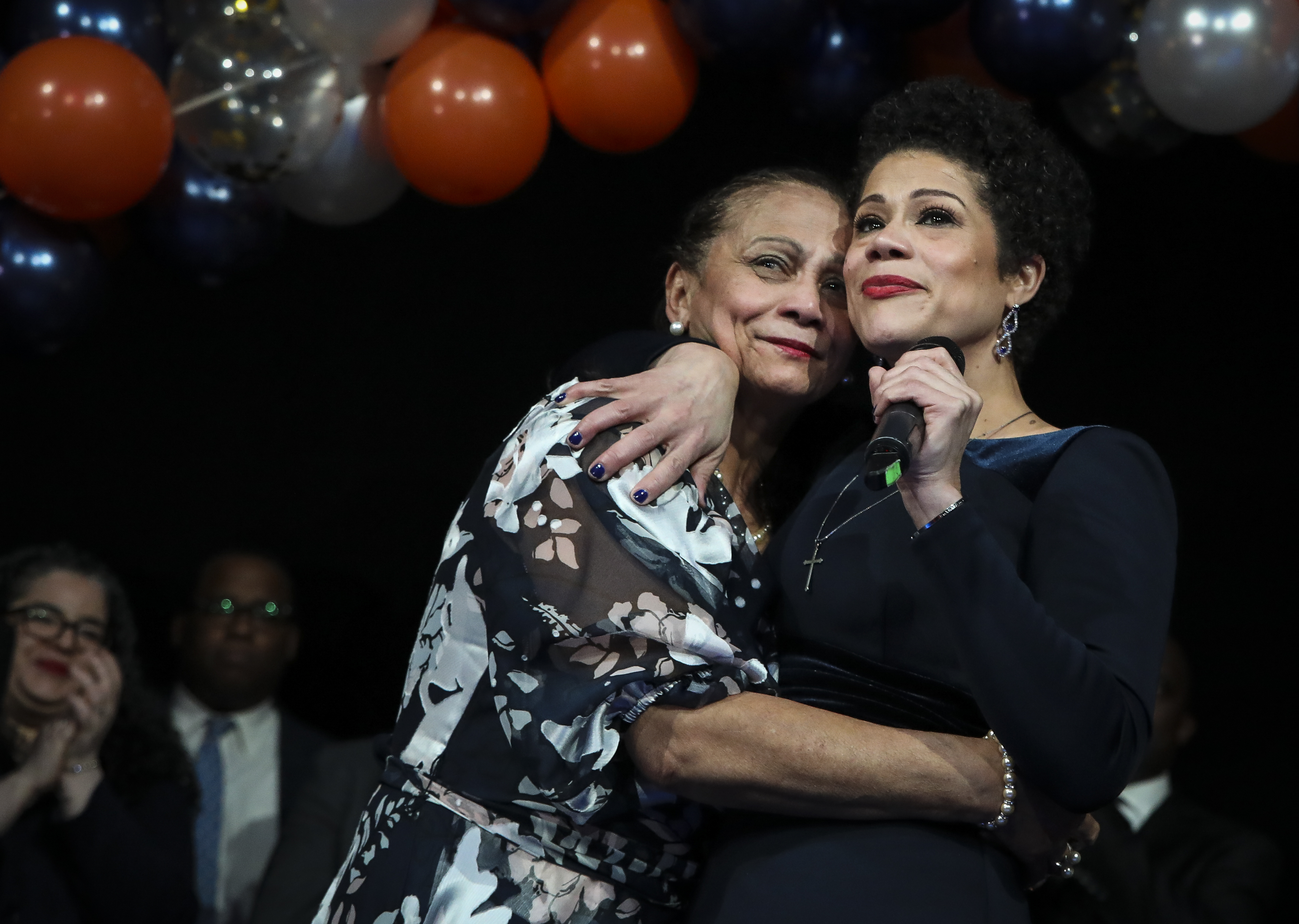 Mirta Peña hugged her daughter and newly elected councilor Julia Mejia at Mejia's inaugural party in Roxbury. Peña, with Mejia in tow, left the Dominican Republic for Boston, and eventually became a US citizen.