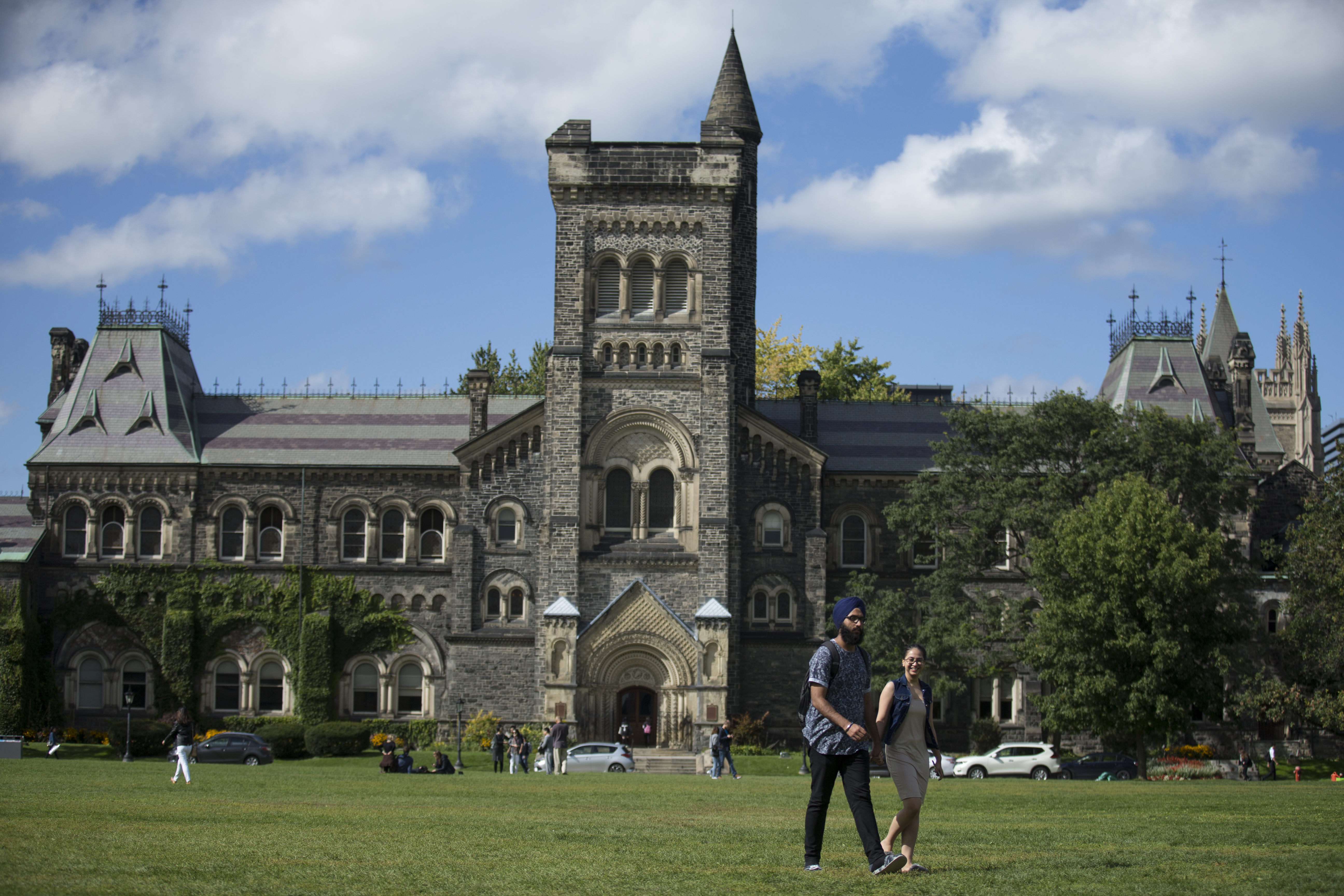 Students walked across the lawn in front of the University of Toronto.