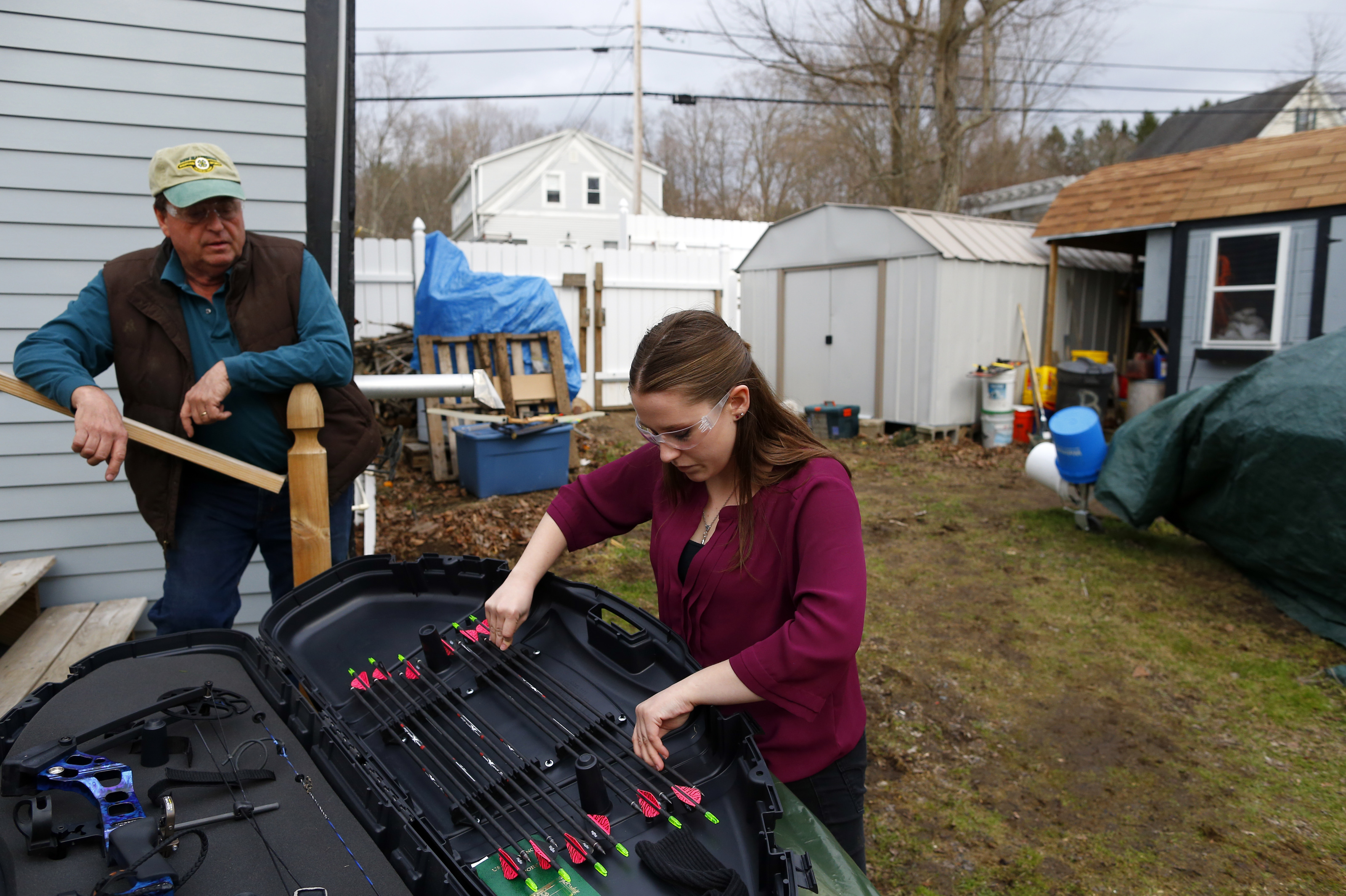 Mike King chatted with his daughter Morgan as she put her arrows away after shooting in their backyard in Epping, N.H.
