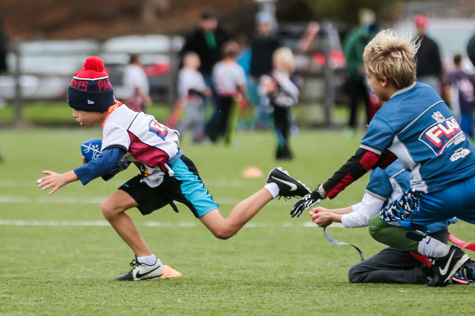 Eight-year-old Sam Myerberg (left), played flag football at Lincoln Park in Lexington.