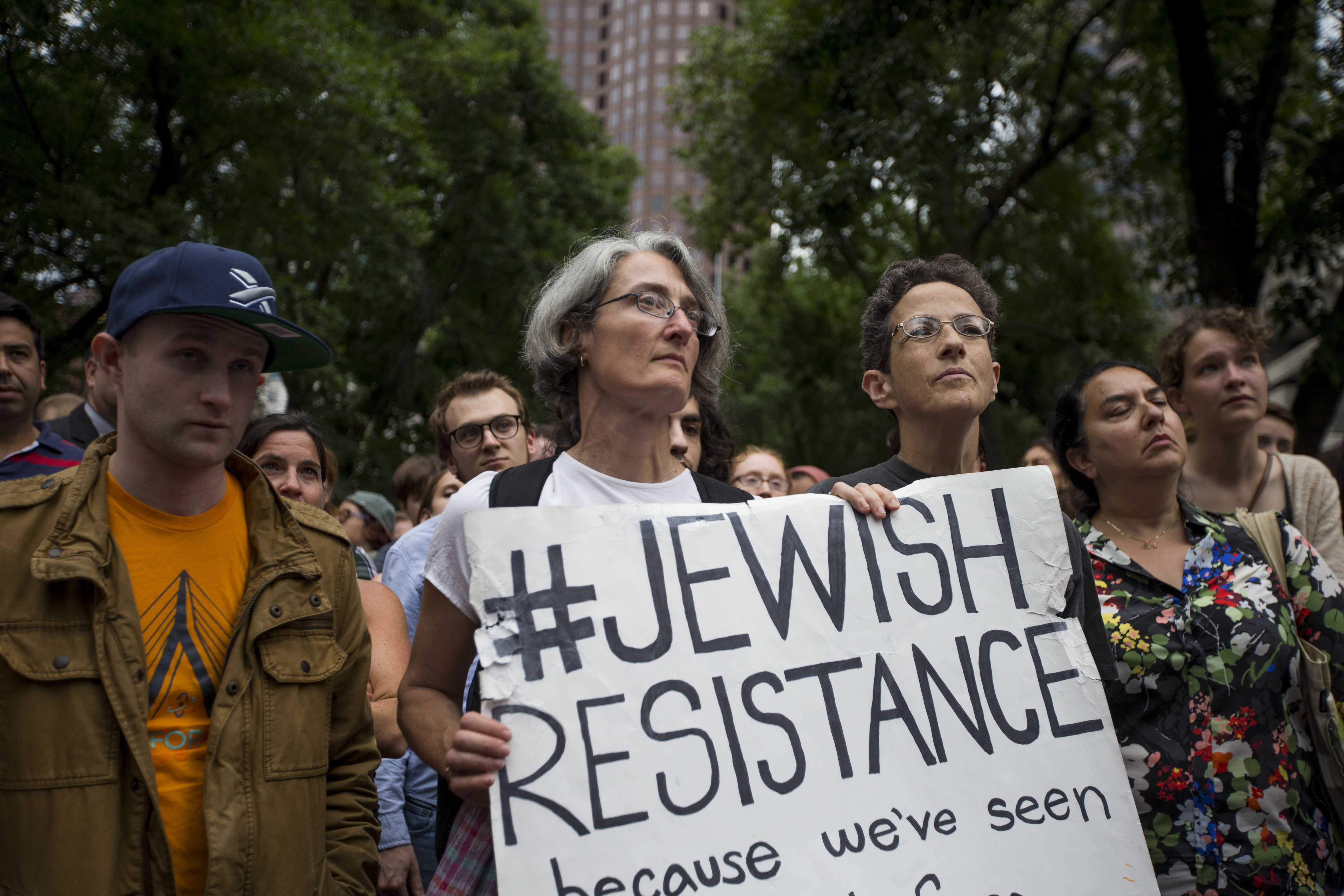 Attendees listen and hold signs during the vigil.