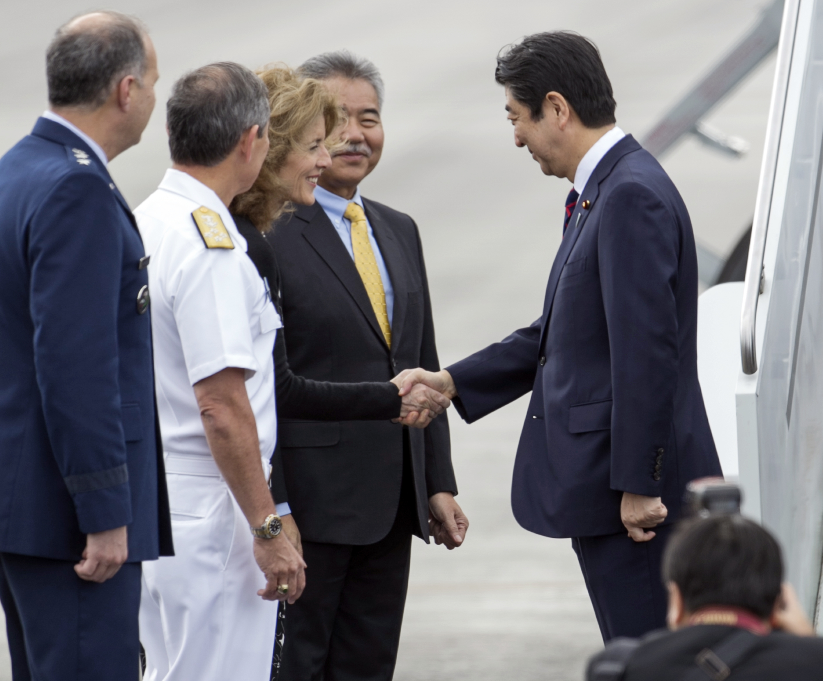 Caroline Kennedy, US ambassador to Japan, greeted Japan's Prime Minister Shinzo Abe at Joint Base Pearl Harbor-Hickam on Monday in Honolulu. Abe will visit Pearl Harbor with President Obama on Tuesday. Marco Garcia/Associated Press