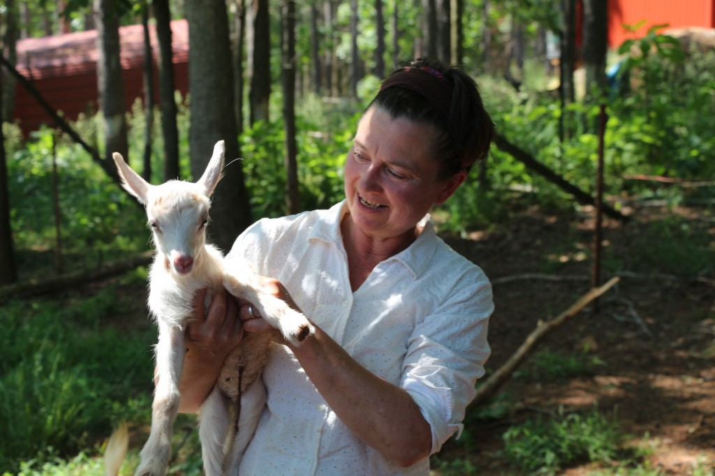 Gail Hobbs-Page with a newborn goat at Caromont Farm in Esmont, Va.