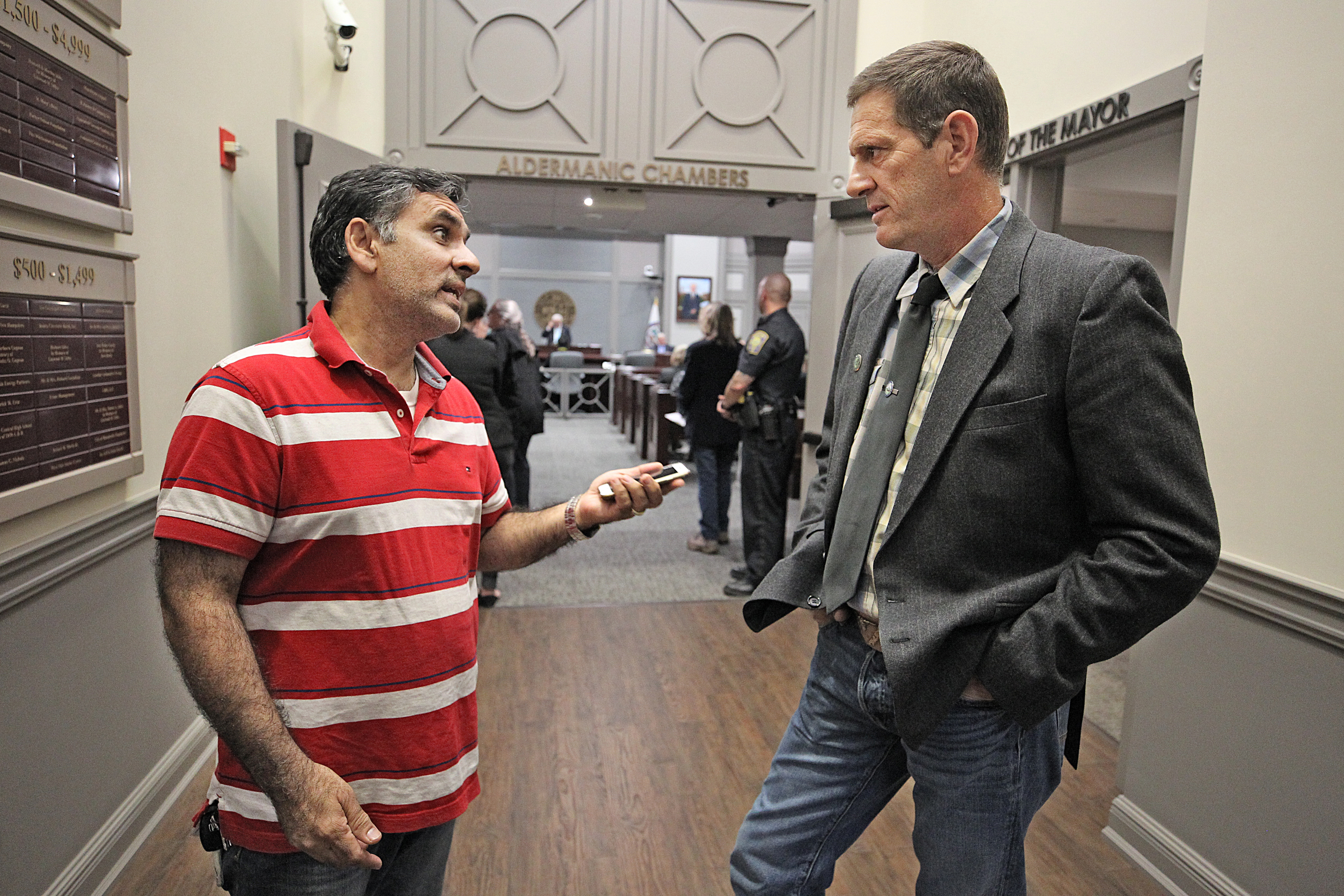 Amjad Rana, society treasurer, spoke with former state legislator Greg Salts after a meeting of the city’s Board of Aldermen.