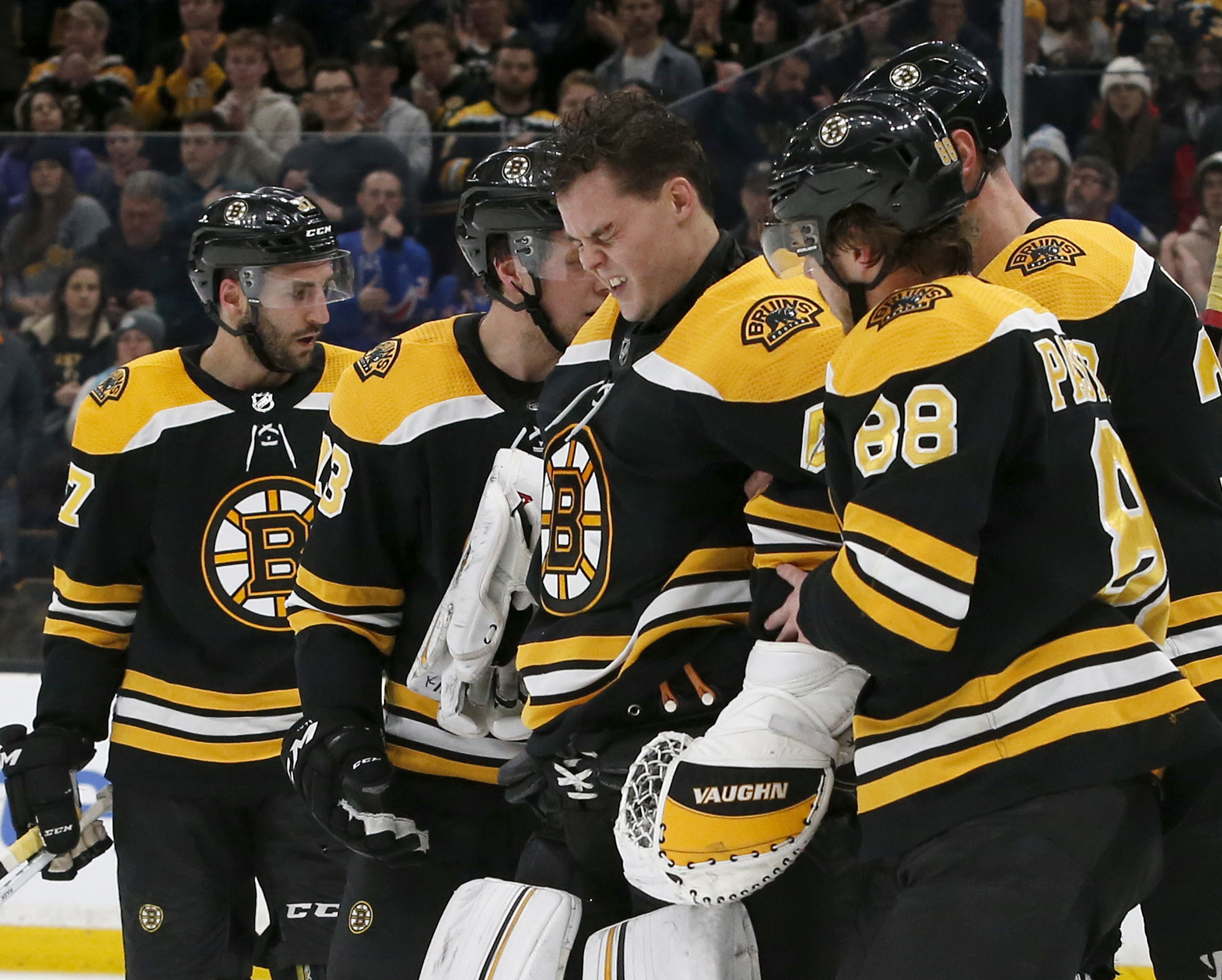 Tuukka Rask (center) is clearly shaken up after the first-period collision Saturday night.