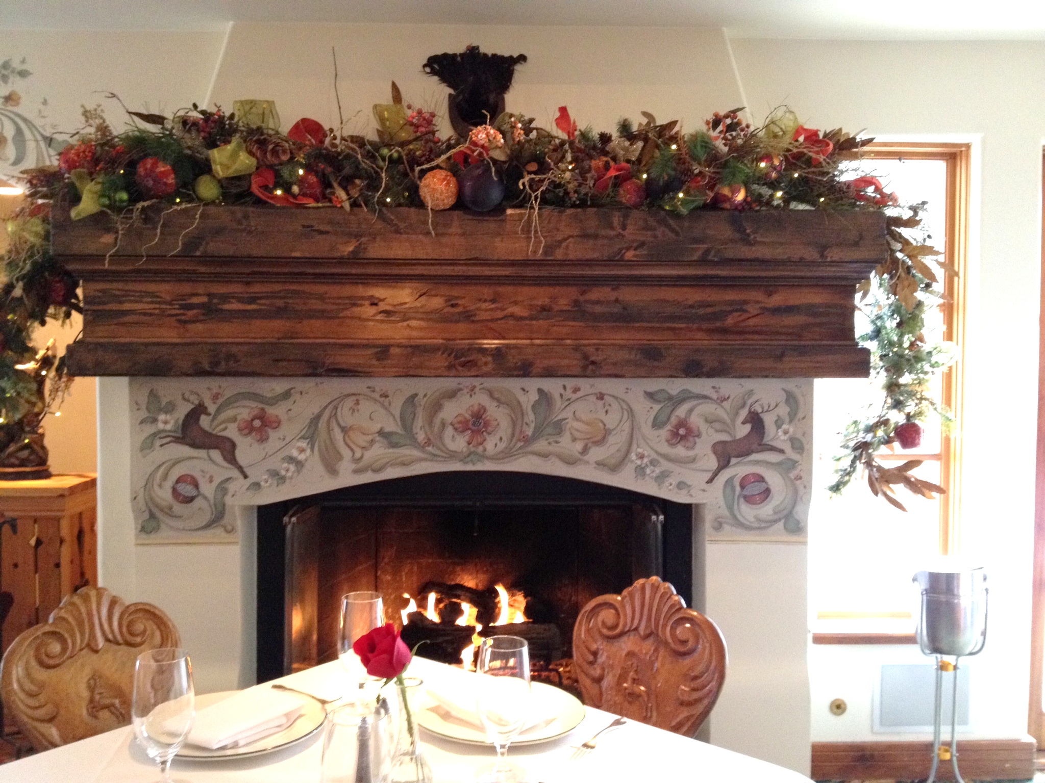 The dining room fireplace and carved chair seatbacks.