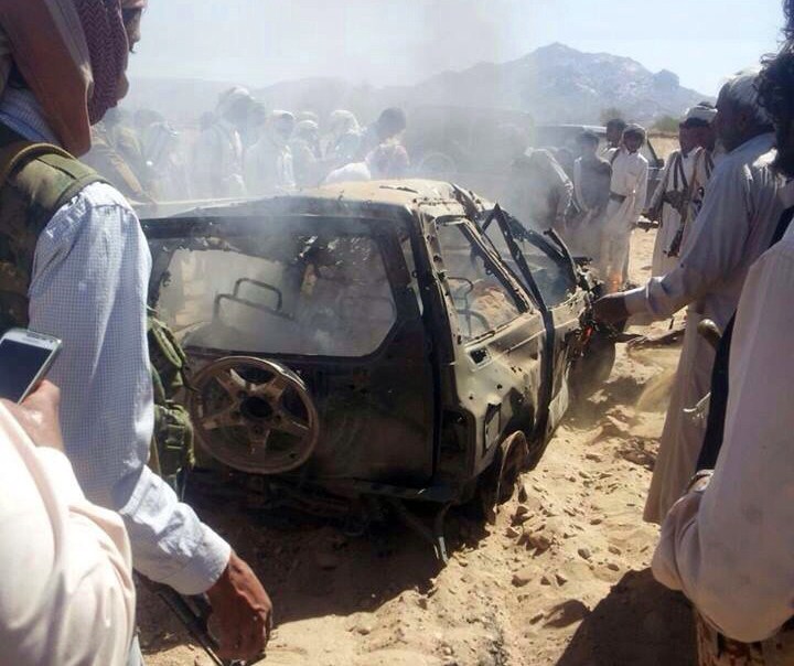 Yemenis gathered around a burnt car after it was struck by a missile fired from a drone in January 2015.