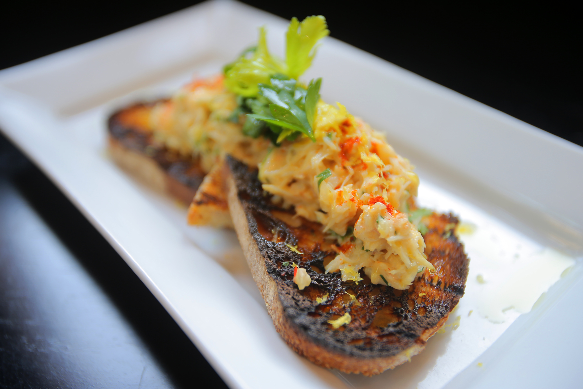 Boston, MA - 02/12/14 - Dining Out review of Row 34 in Fort Point. Deviled crab toast with smoked paprika and celery salad. Lane Turner/Globe Staff Section: FOOD Reporter: Devra First Slug: 19dinpic