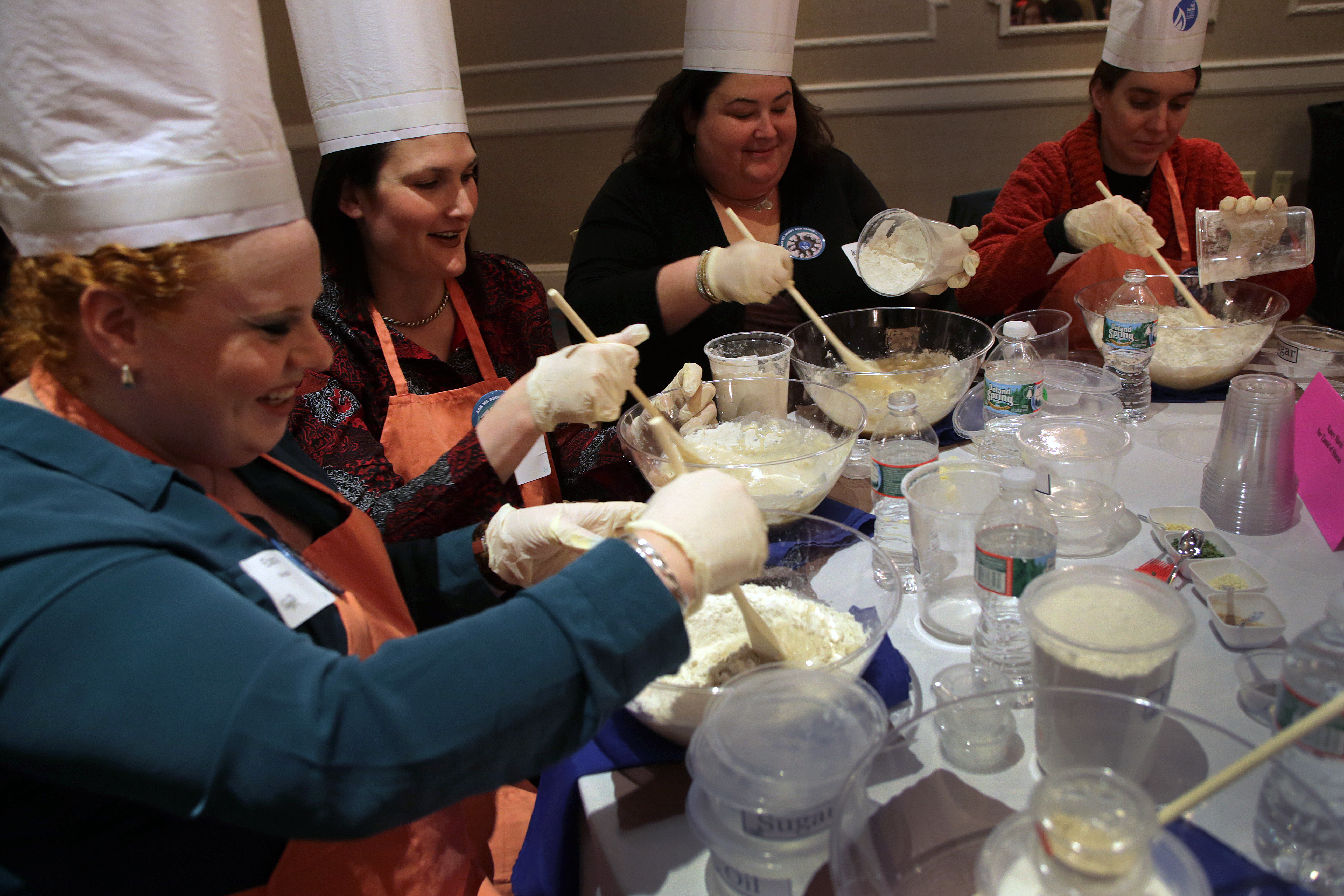 From left: Elana Margolis of Sharon, Nancy Hait of Easton, Deborah Daniels of West Bridgewater, and Nancy Marin of Mansfield making challah, a braided bread, during the Mega Challah Bake.