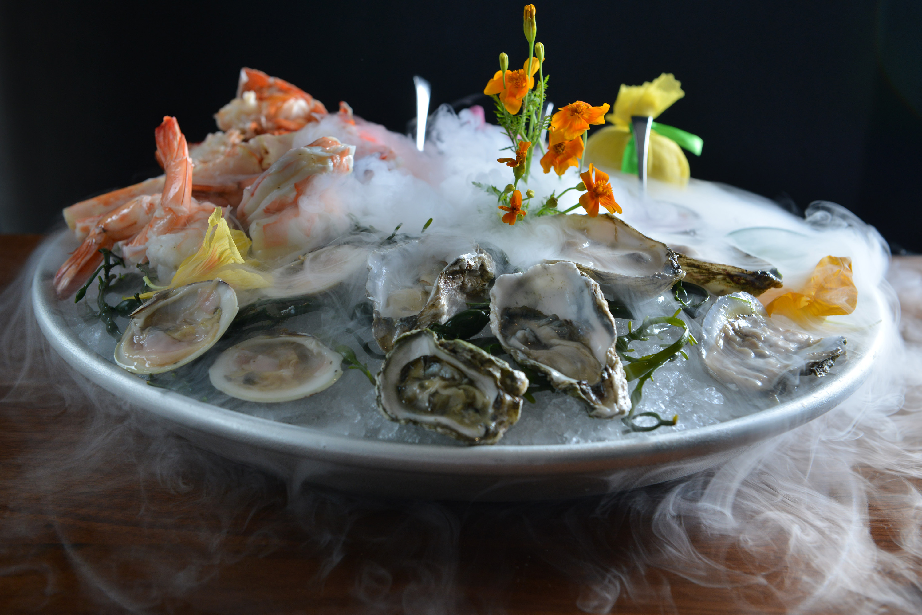 Seafood tower served in a fog of dry ice.