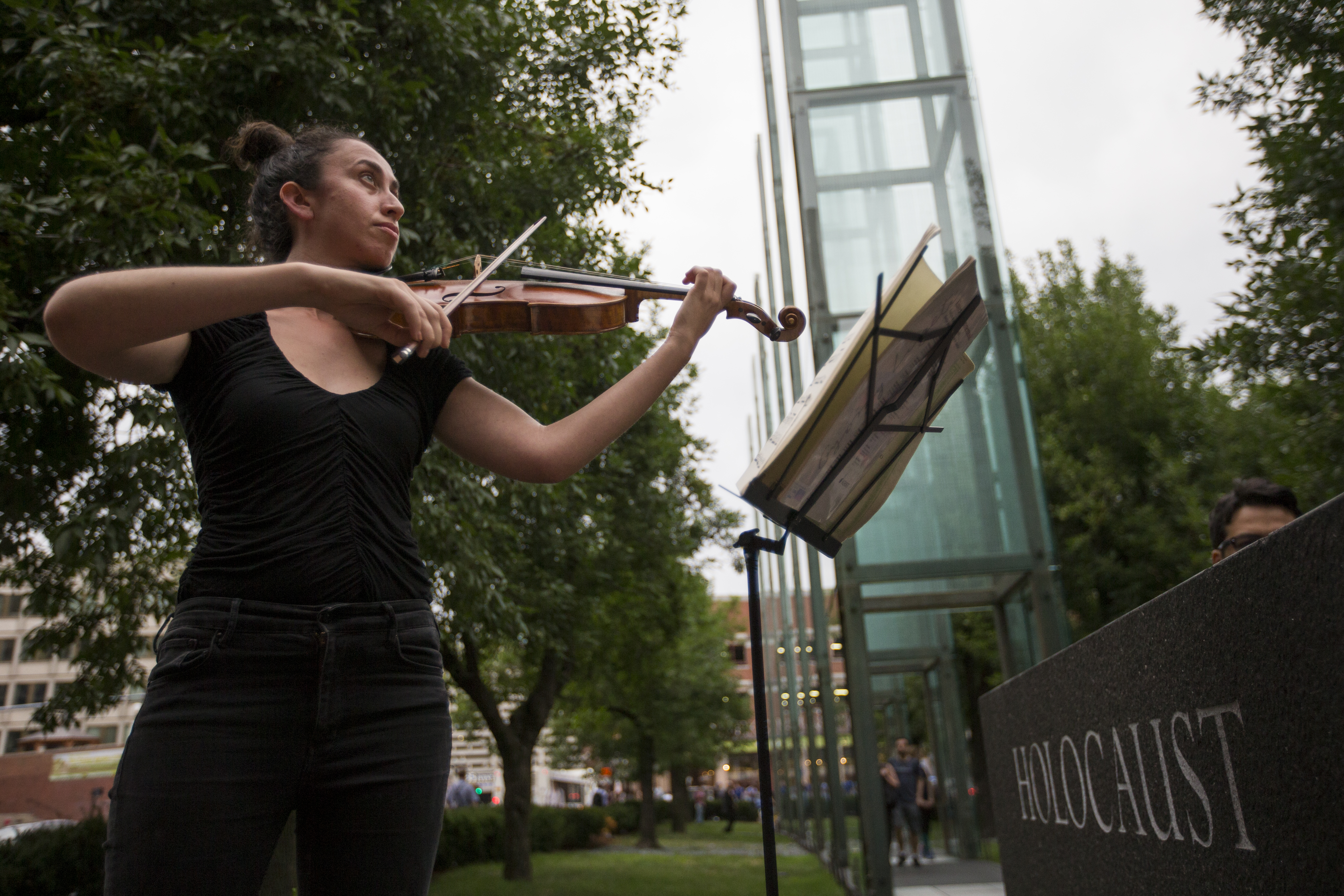 Eve Boltax, from Jamaica Plain, plays her violin during the vigil.