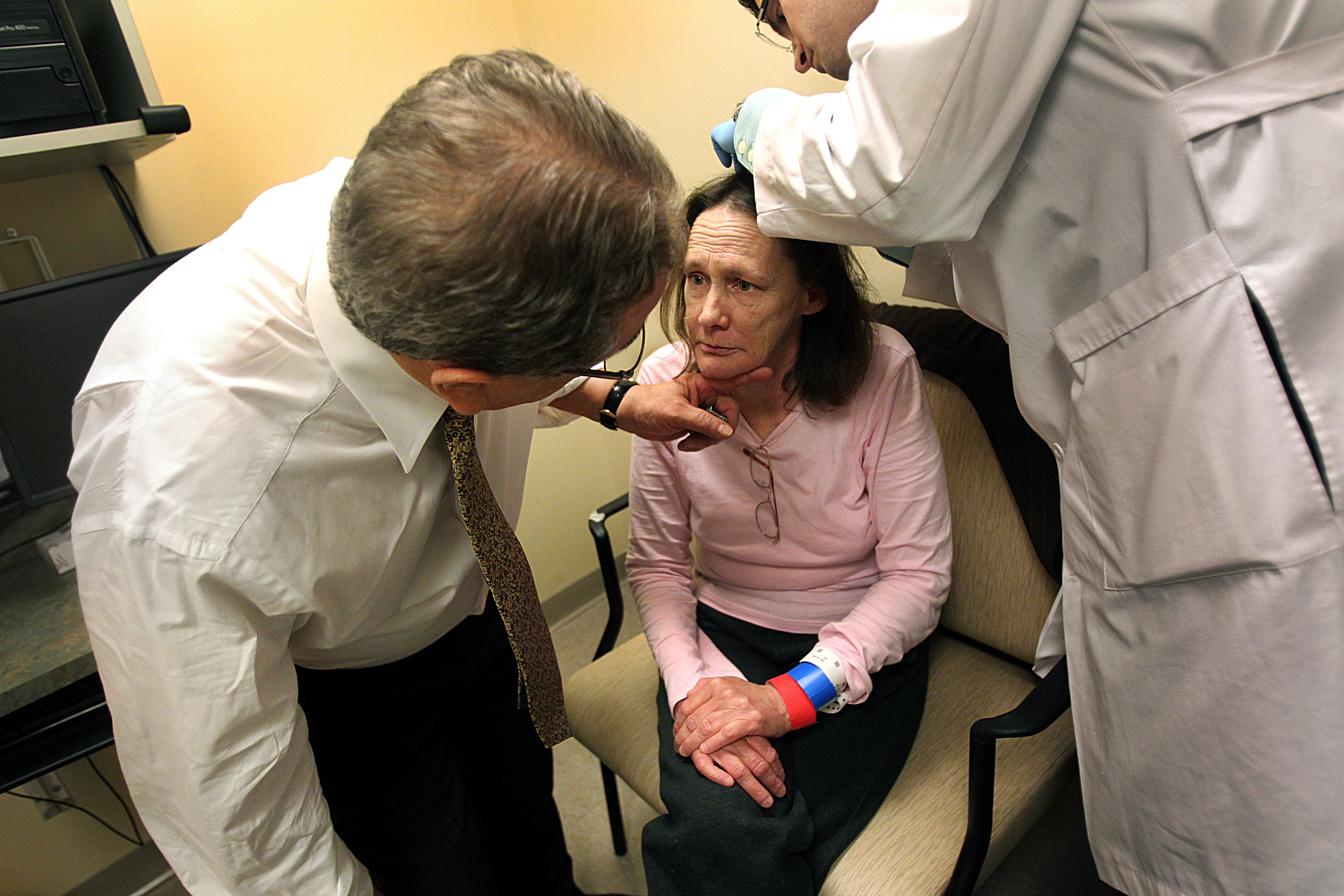 Dr. Ernesto Gonzalez (left) examines Ellen Ferrante while volunteering with the Boston Health Care for the Homeless Program.