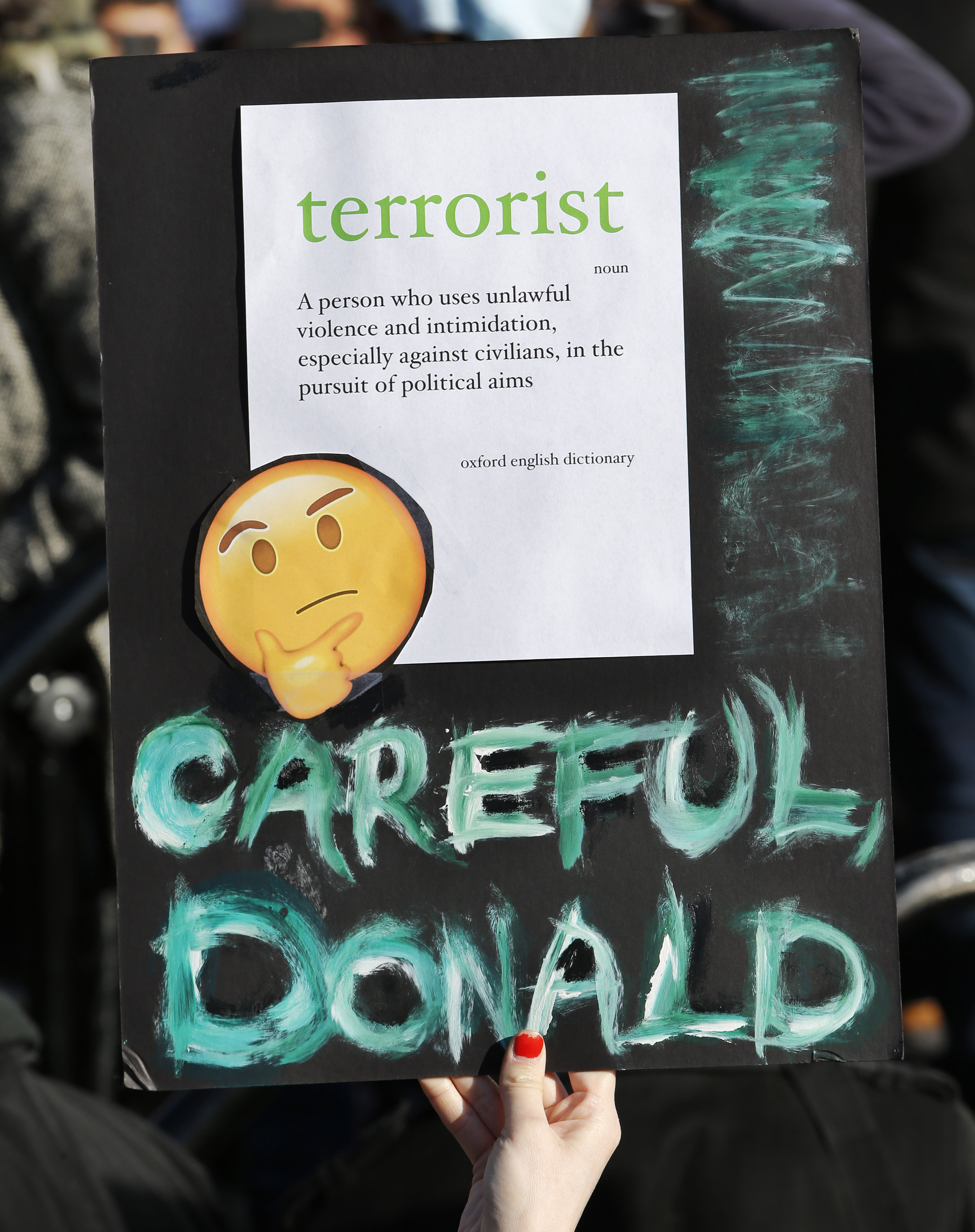 A woman holds up a sign at an immigrants’ rights rally on Jan. 29 in New York.