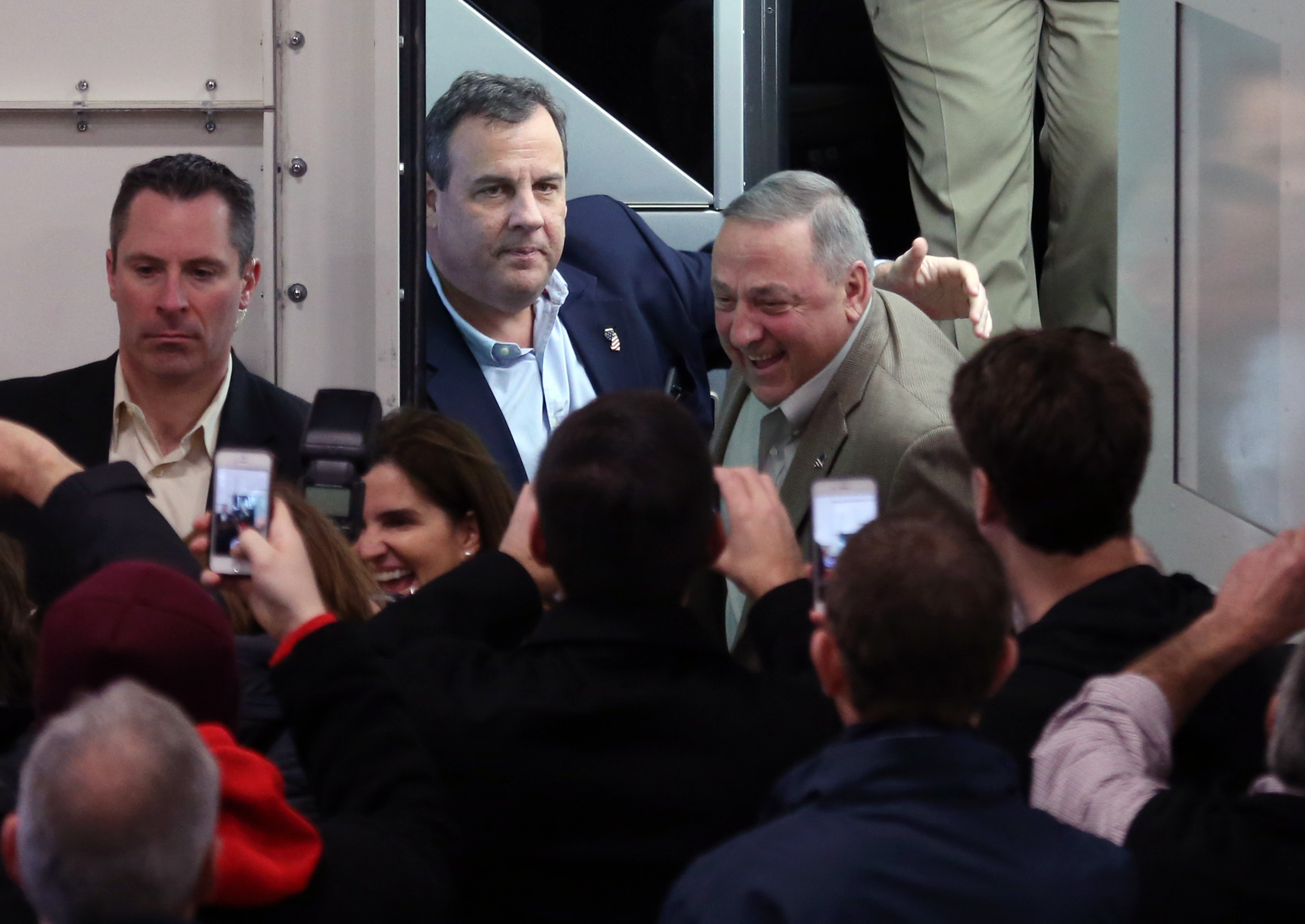 Republican presidential candidate New Jersey Gov. Chris Christie patted Maine Gov. Paul LePage on the back as they exit a tour bus during a campaign stop in Exeter, N.H. on December 19.