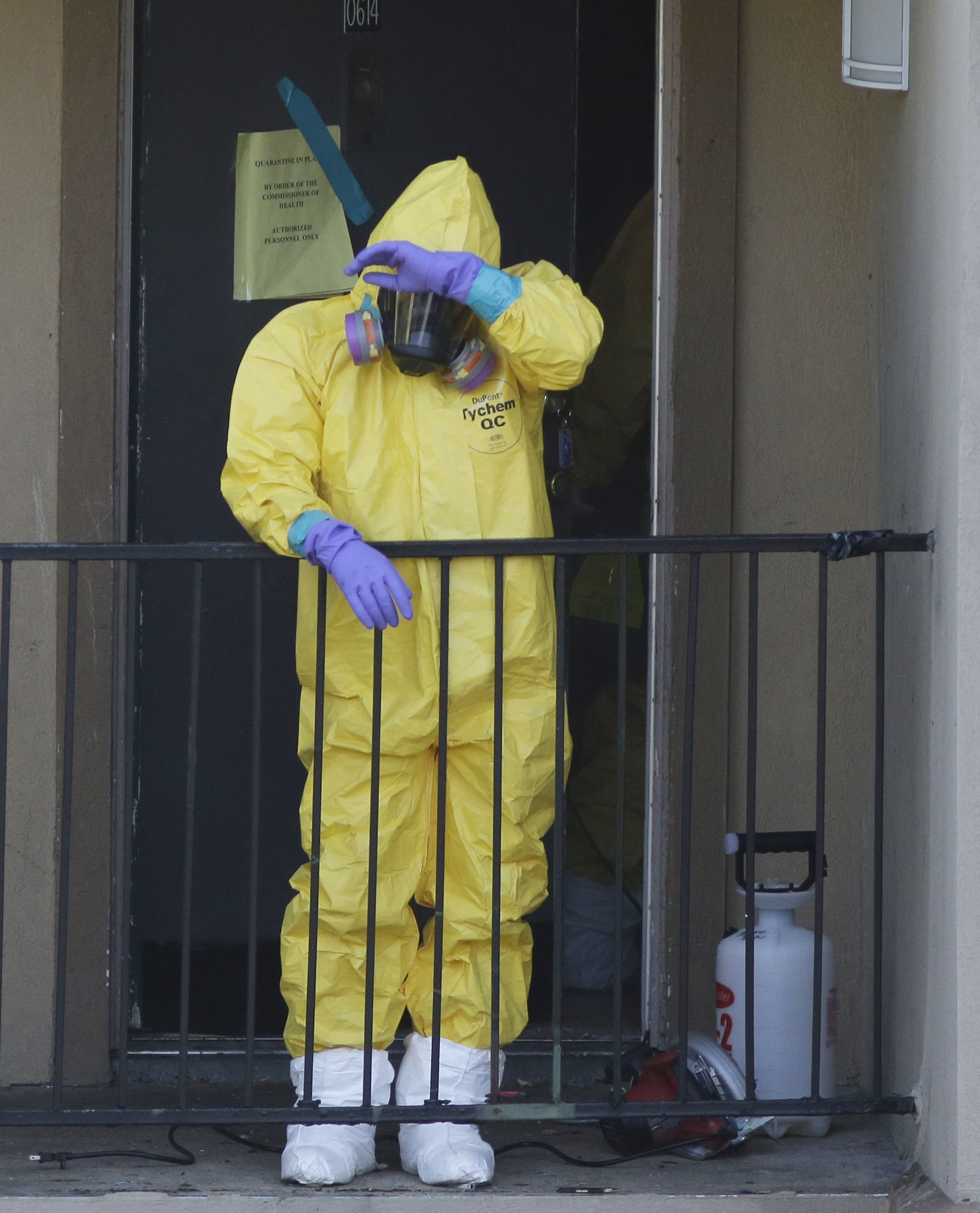 A hazardous materials worker took a break from cleaning an apartment in Dallas, where an Ebola patient stayed last week.