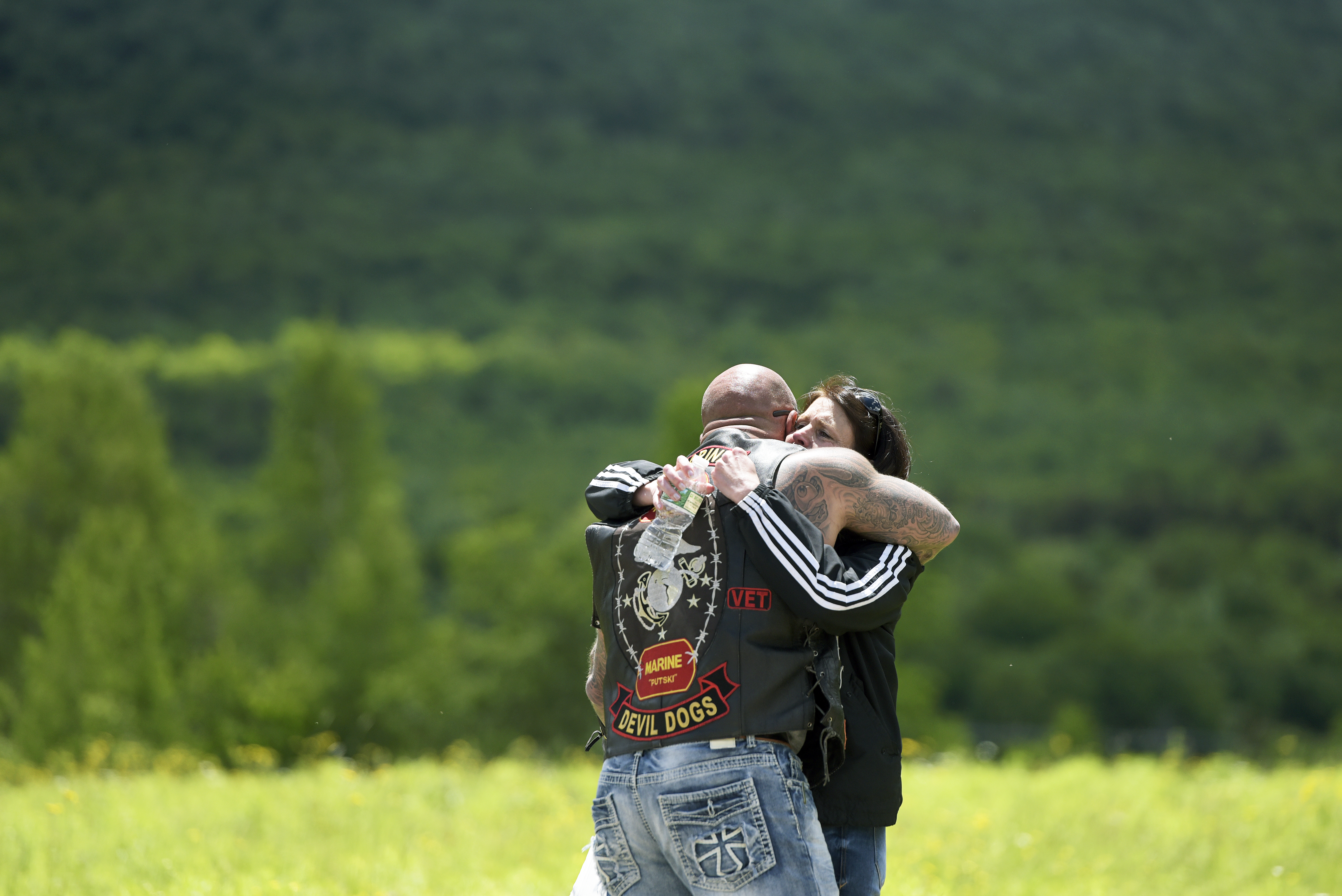 A motorcyclist was consoled Saturday at the scene of the crash.