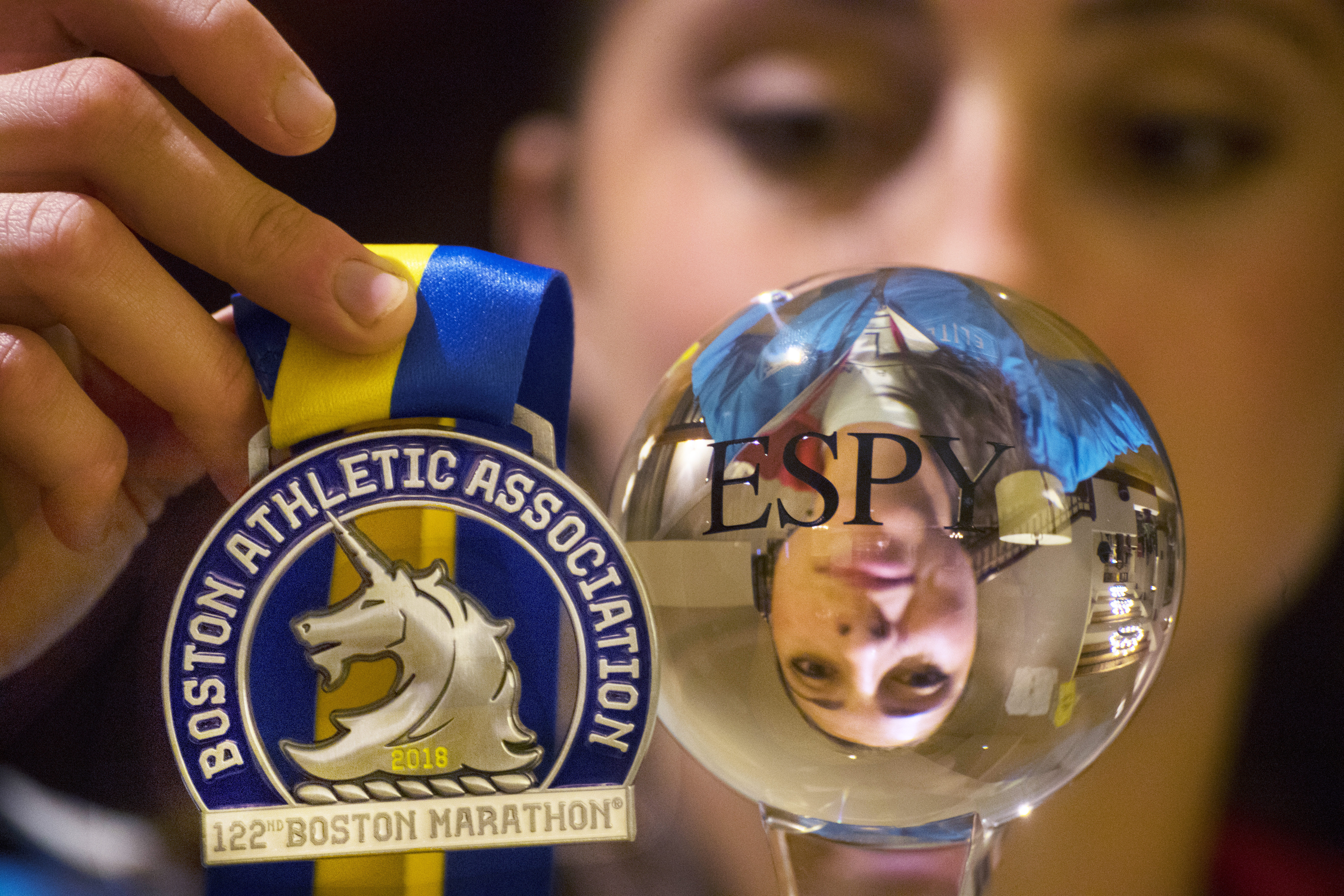 Sellers with her Boston Marathon medal and an honorary ESPY she won for her achievement.
