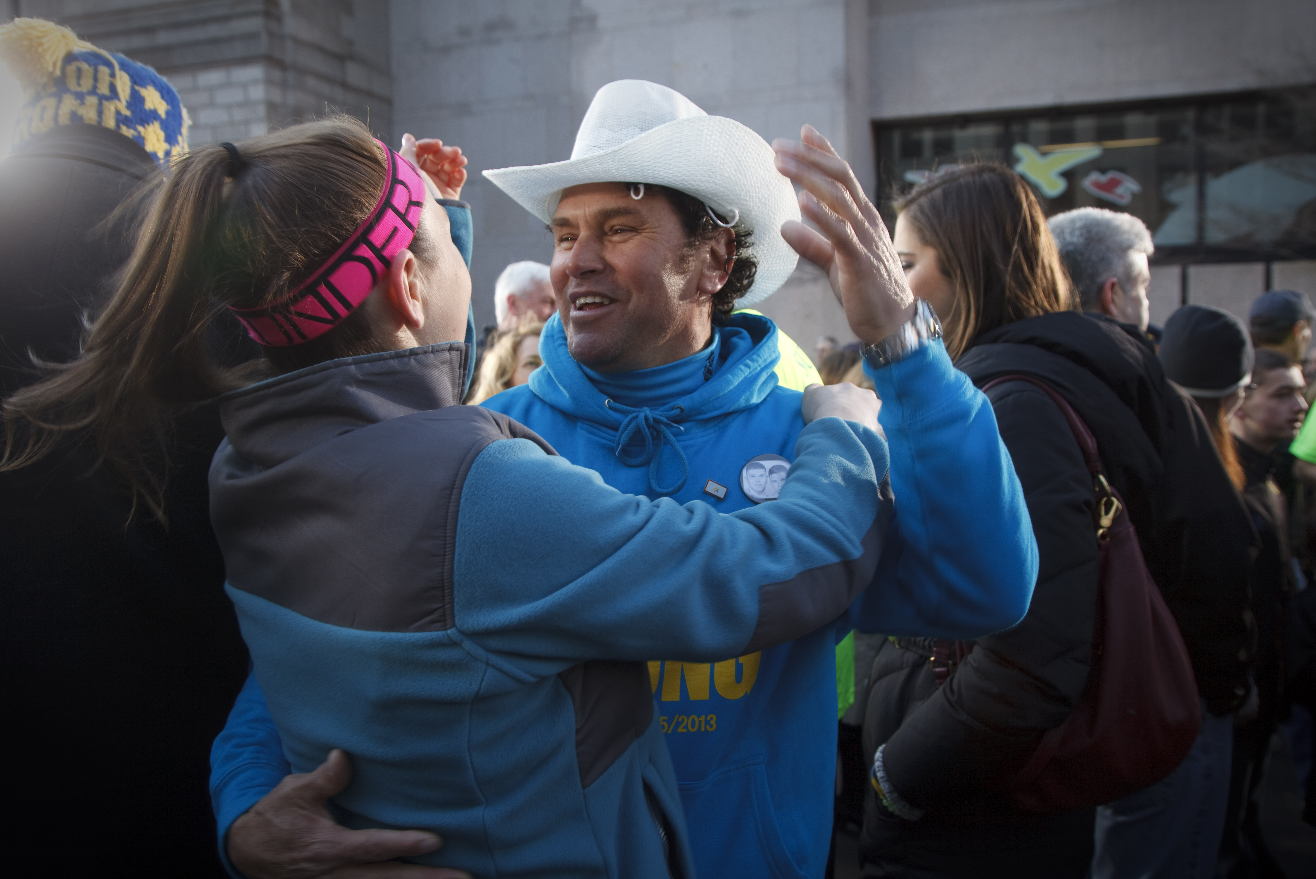 Carlos Arredondo participated in a group photo at the Boston Marathon finish line.