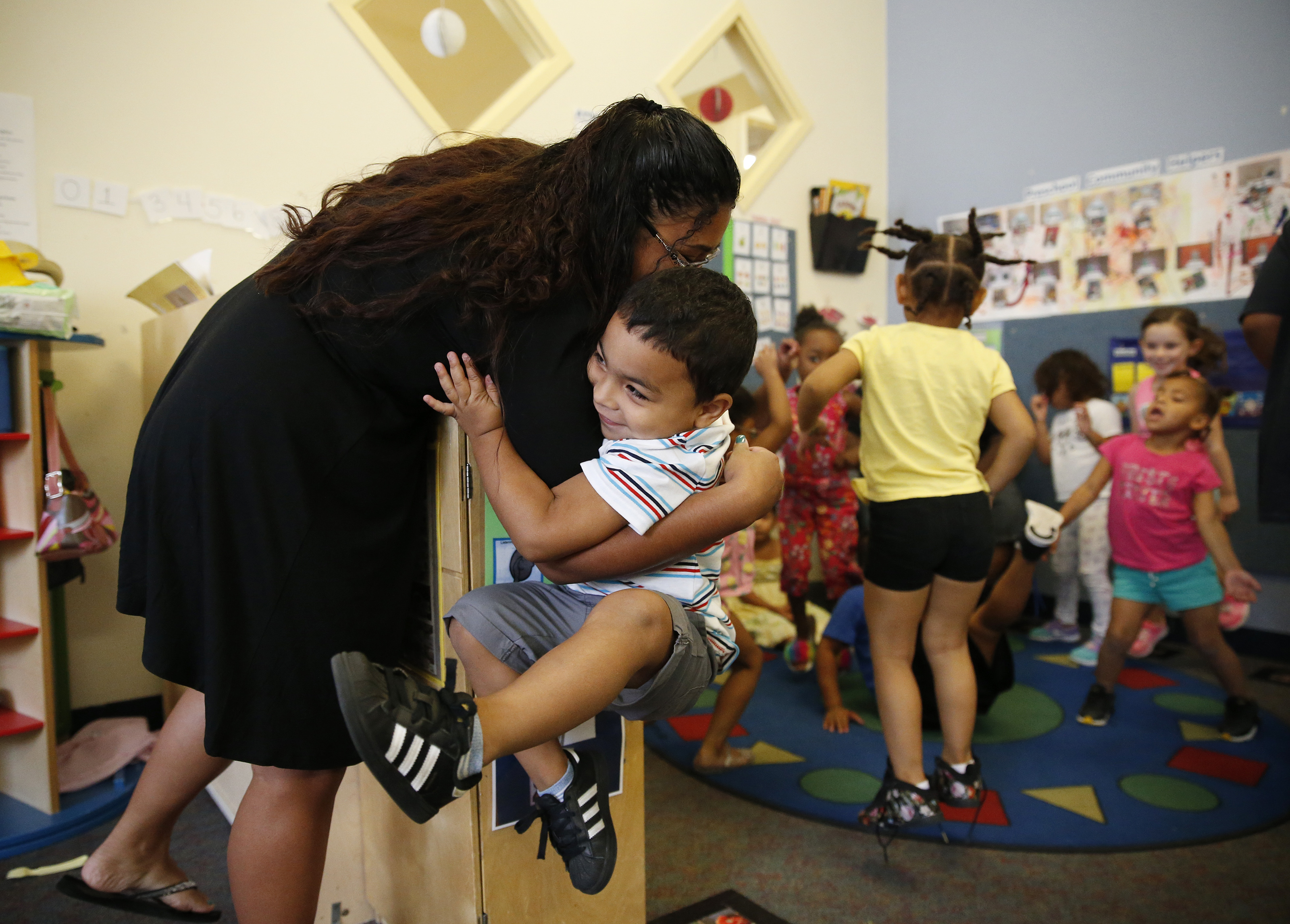 Ayden, 4, hugged his mother, Itzamarie, (left) during a summer educational program at Horizons for Homeless Children.