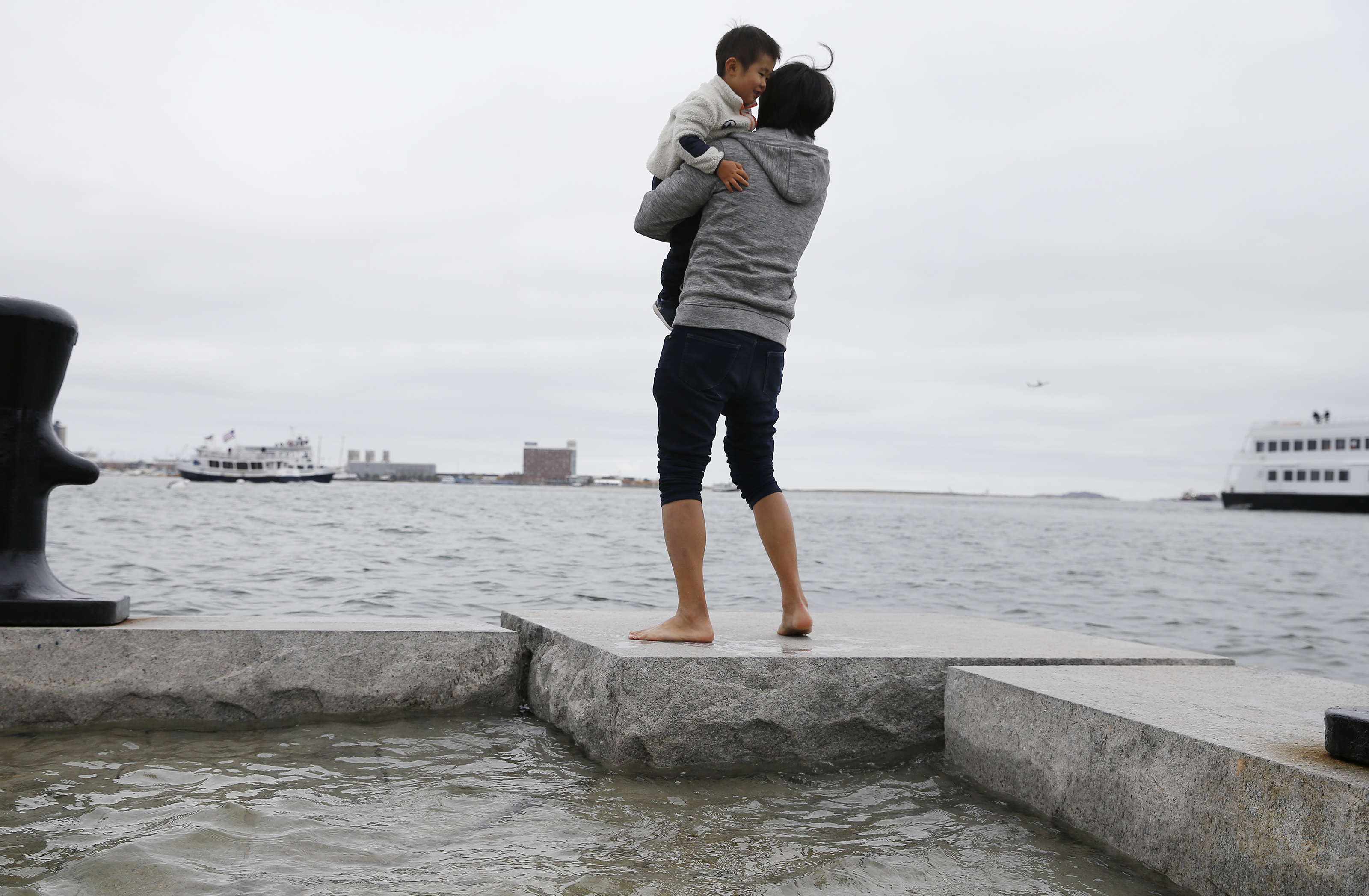 A father held his 27-month-old son as they looked out over the water.