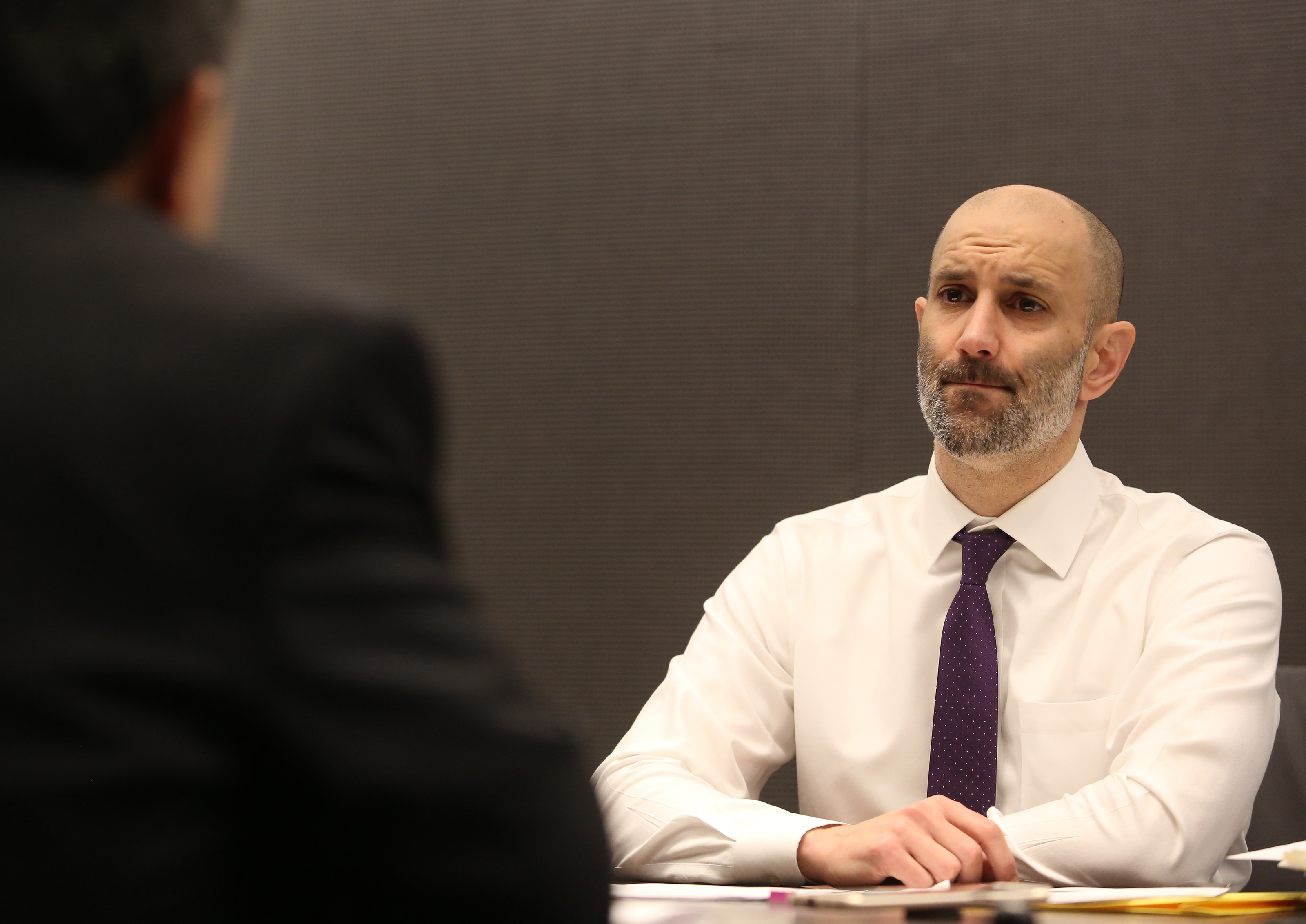 Dr. Assaad Sayah, chief medical officer (left) listened as Pete DeMarco asked him a question about the death of his wife, Laura Levis.