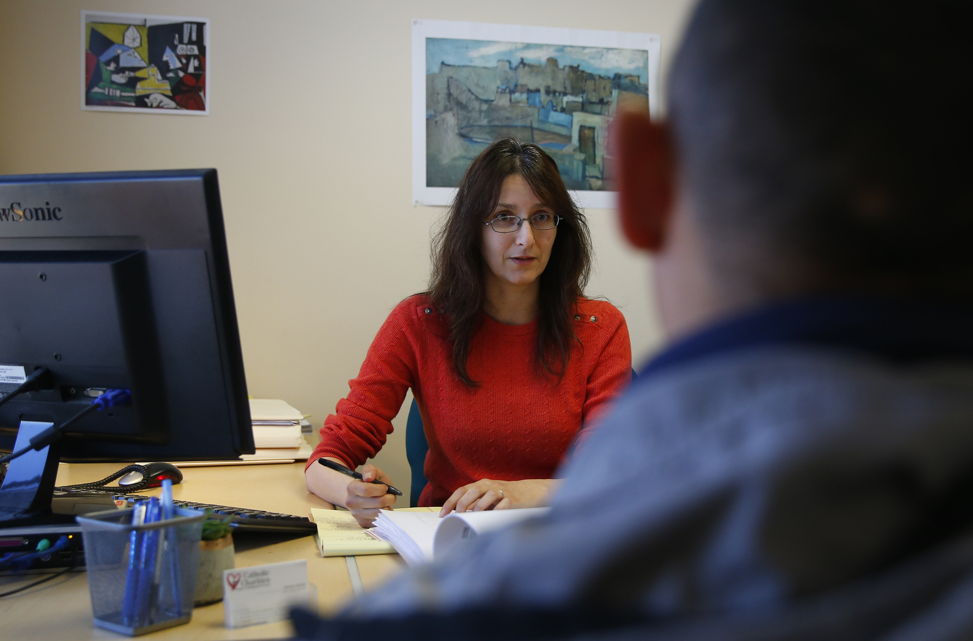 Mariam Liberles, an immigration lawyer and supervising attorney at Catholic Charities’ Immigration Legal Services, met with a client at her office.