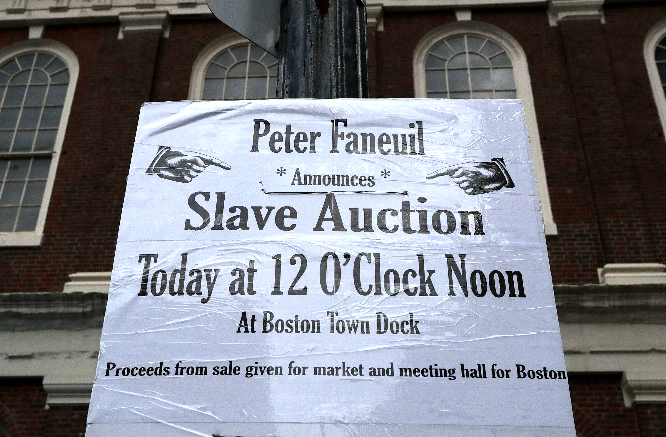 A sign promoted the rally outside Faneuil Hall.