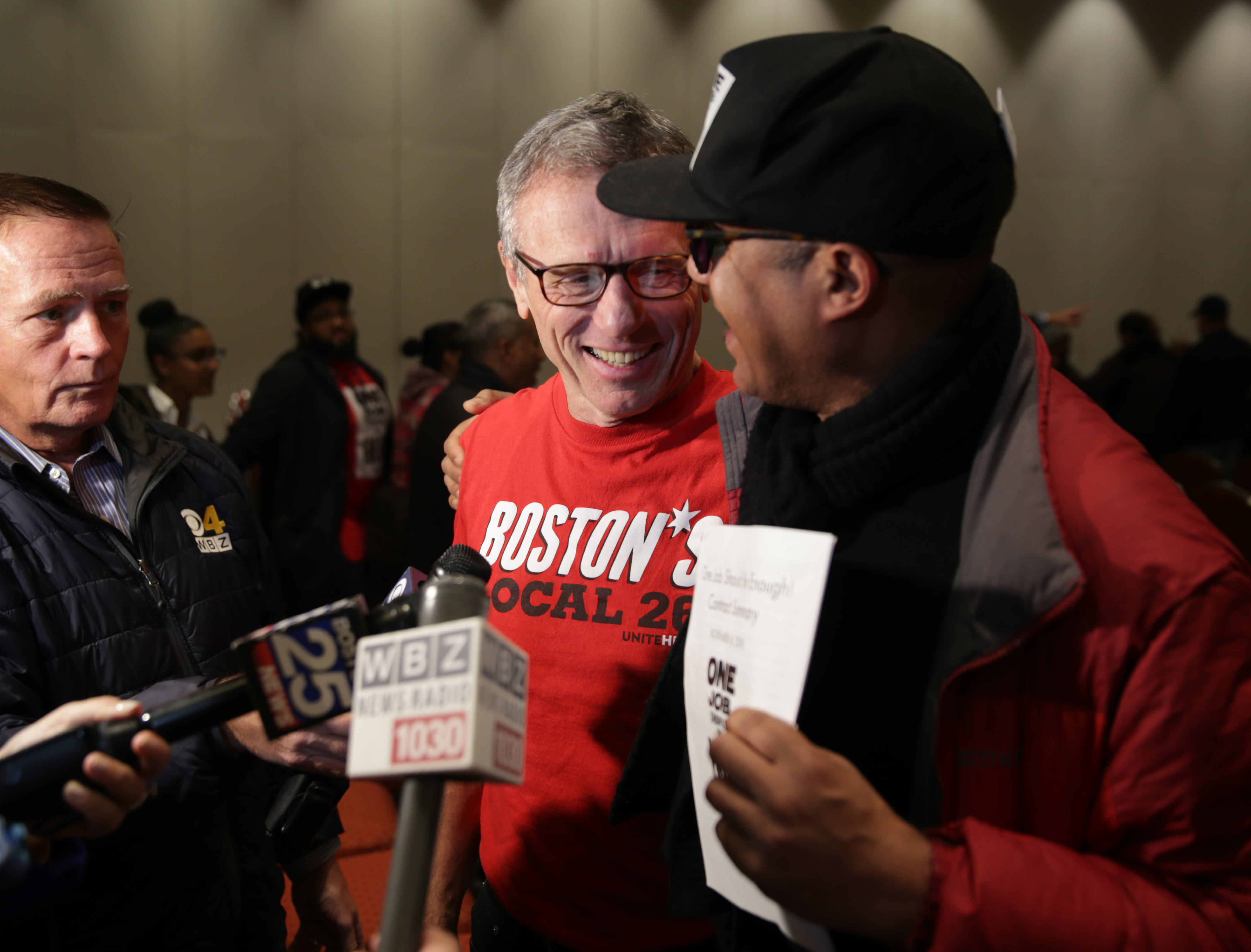 Brian Lang (center), president of Unite Here Local 26, spoke to reporters Saturday after the deal was announced.