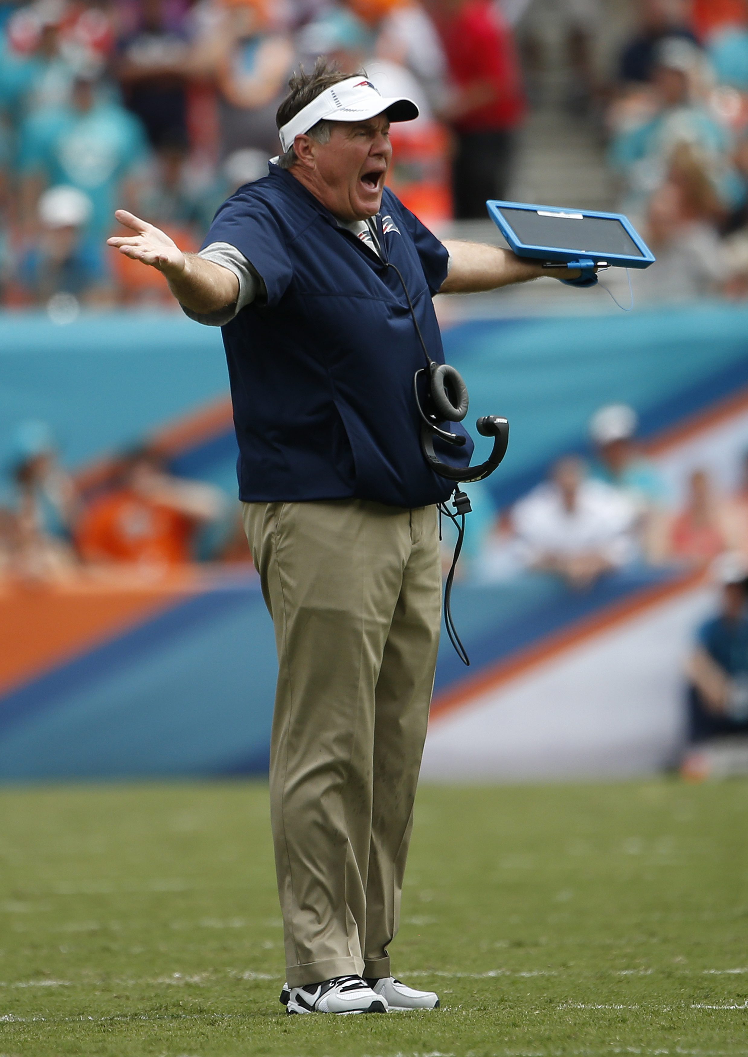Bill Belichick reacted to a call on Sunday. Like other coaches, he uses an NFL-supplied tablet during the games.