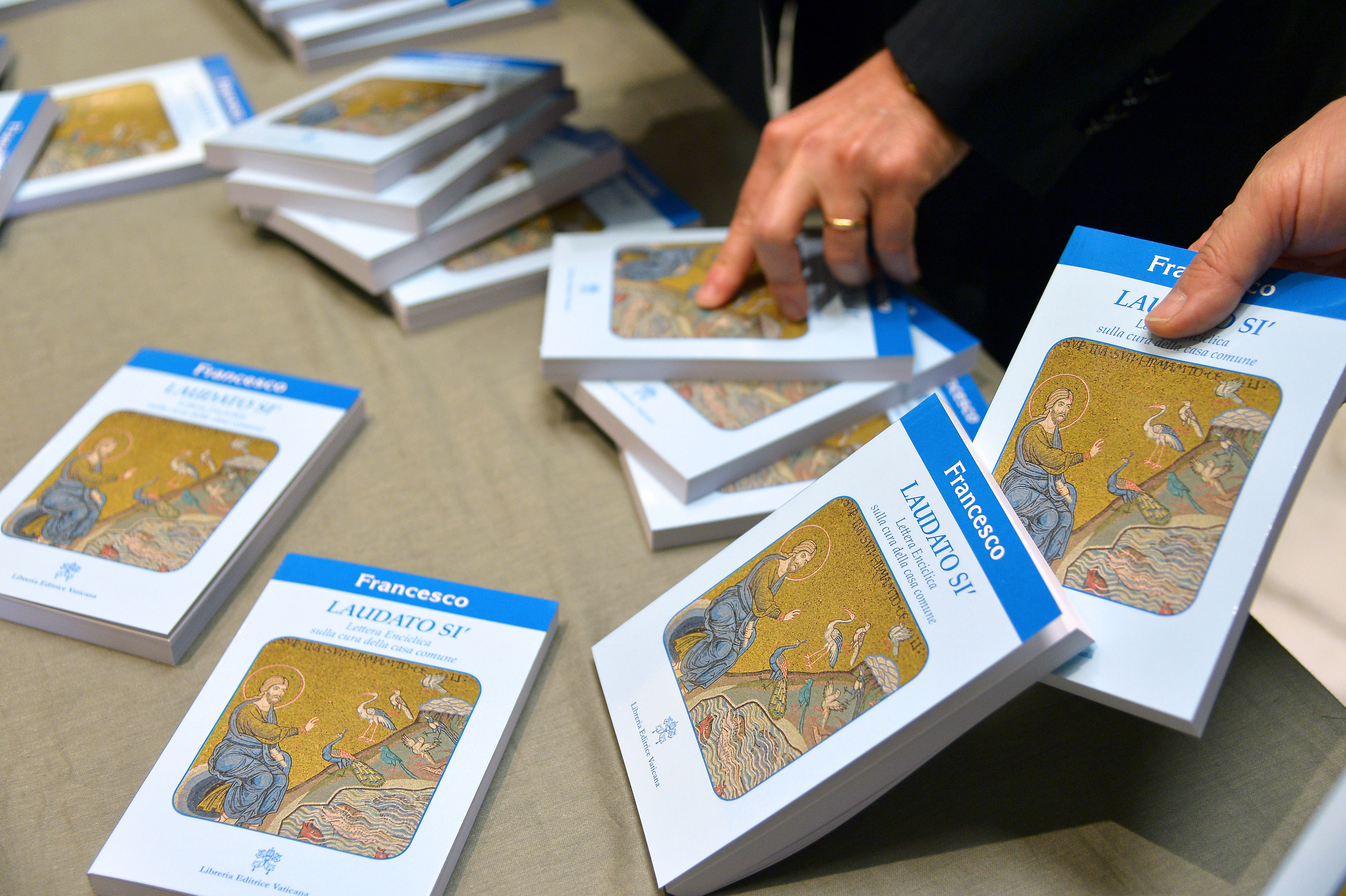People held copies of “Laudato Si” in 2015, during its official unveiling at the Vatican.