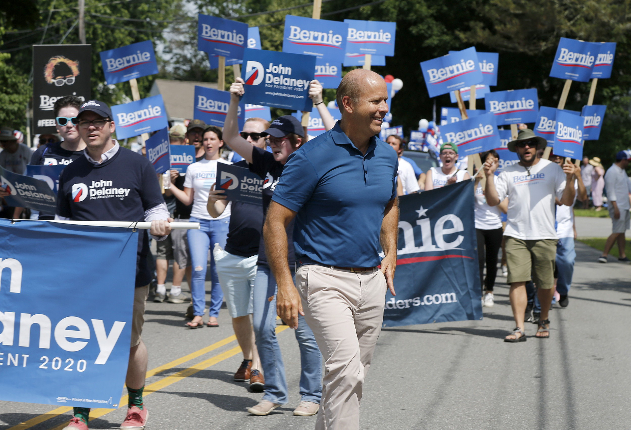 Former representative John Delaney walked along the route ahead of supporters of Bernie Sanders during the parade.