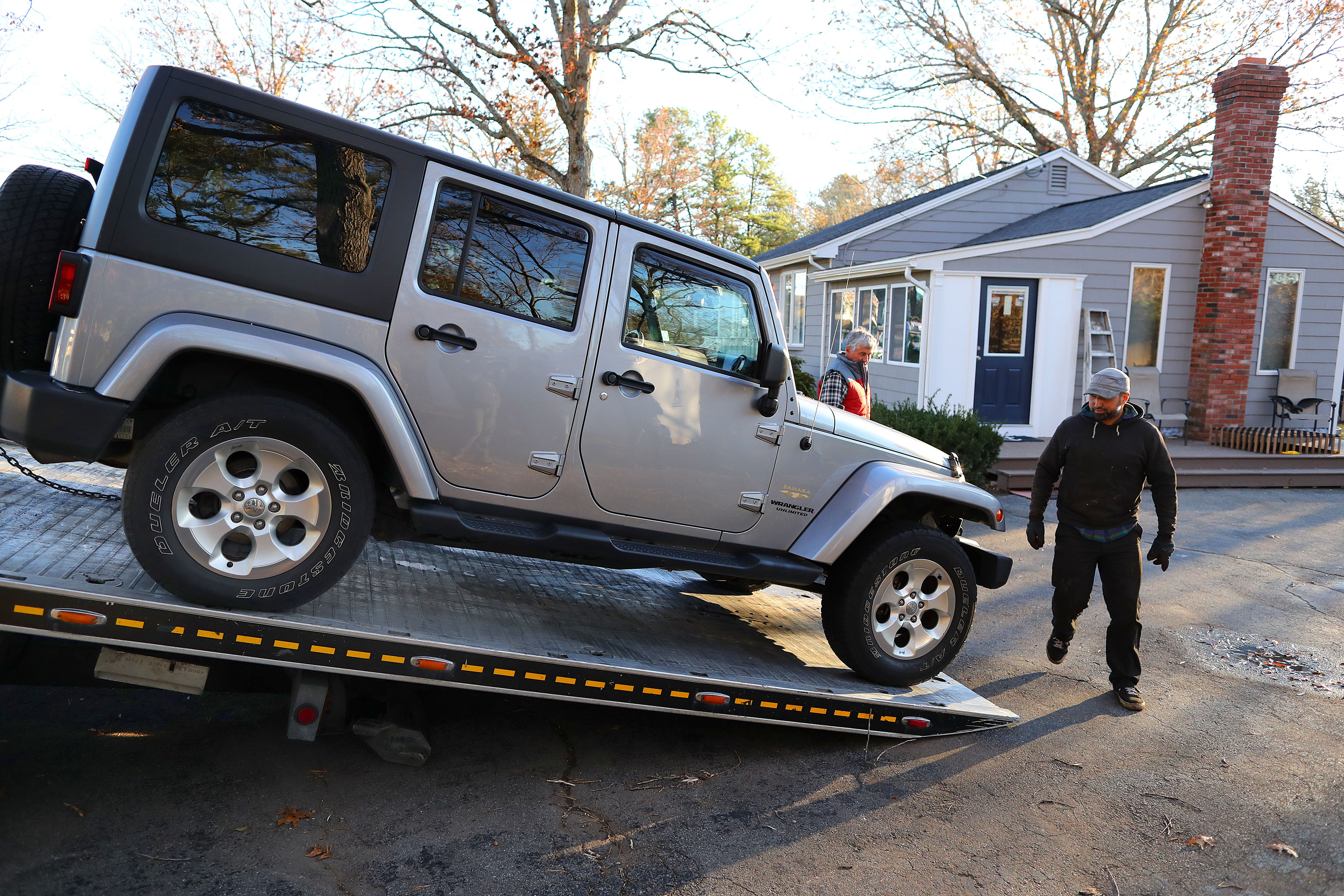 A flatbed tow truck removed the Jeep from the driveway of the home belonging to the Principal of Bellingham High School, Lucas Giguere.