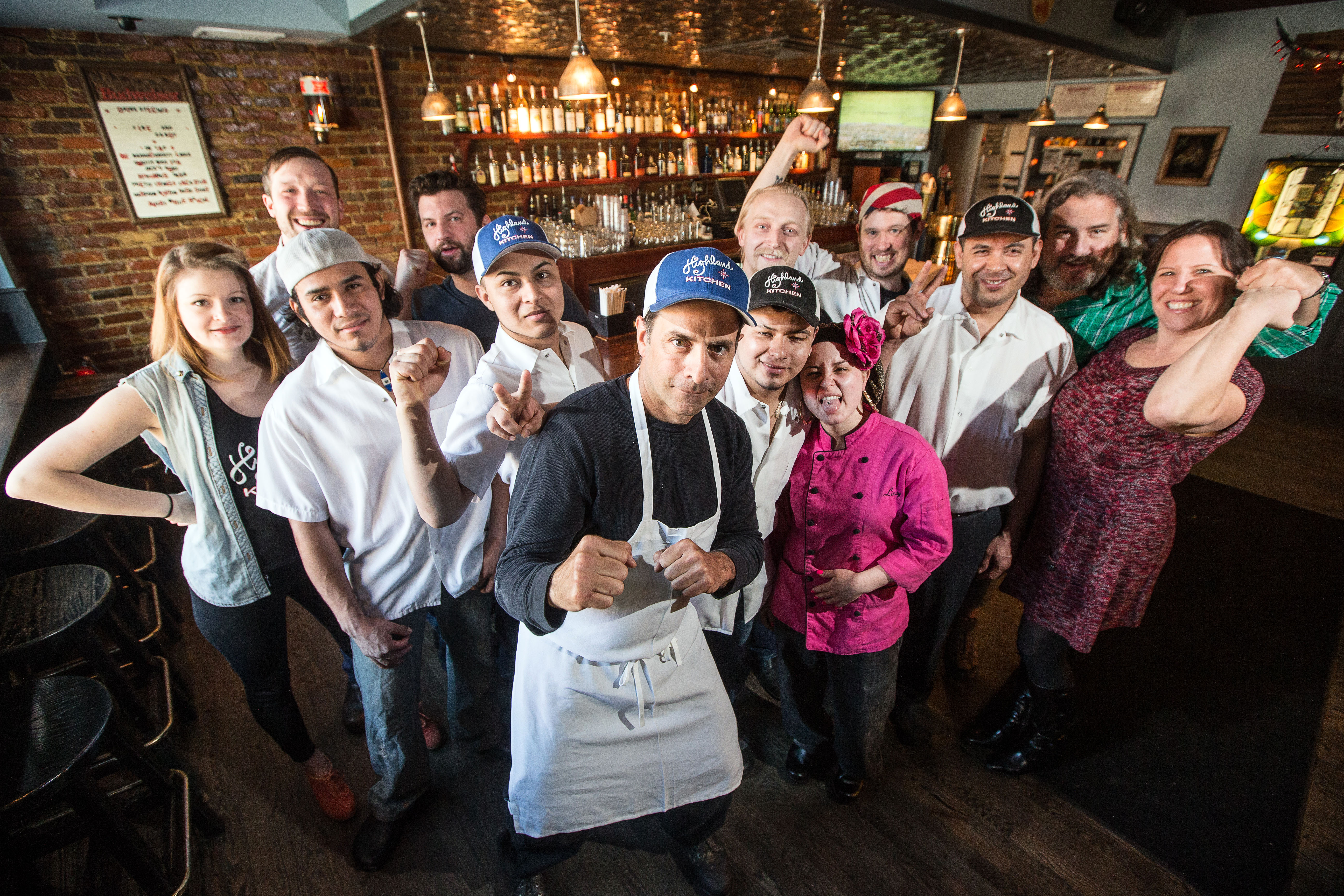 Chef-owner Mark Romano with members of his staff at Highland Kitchen in Somerville.