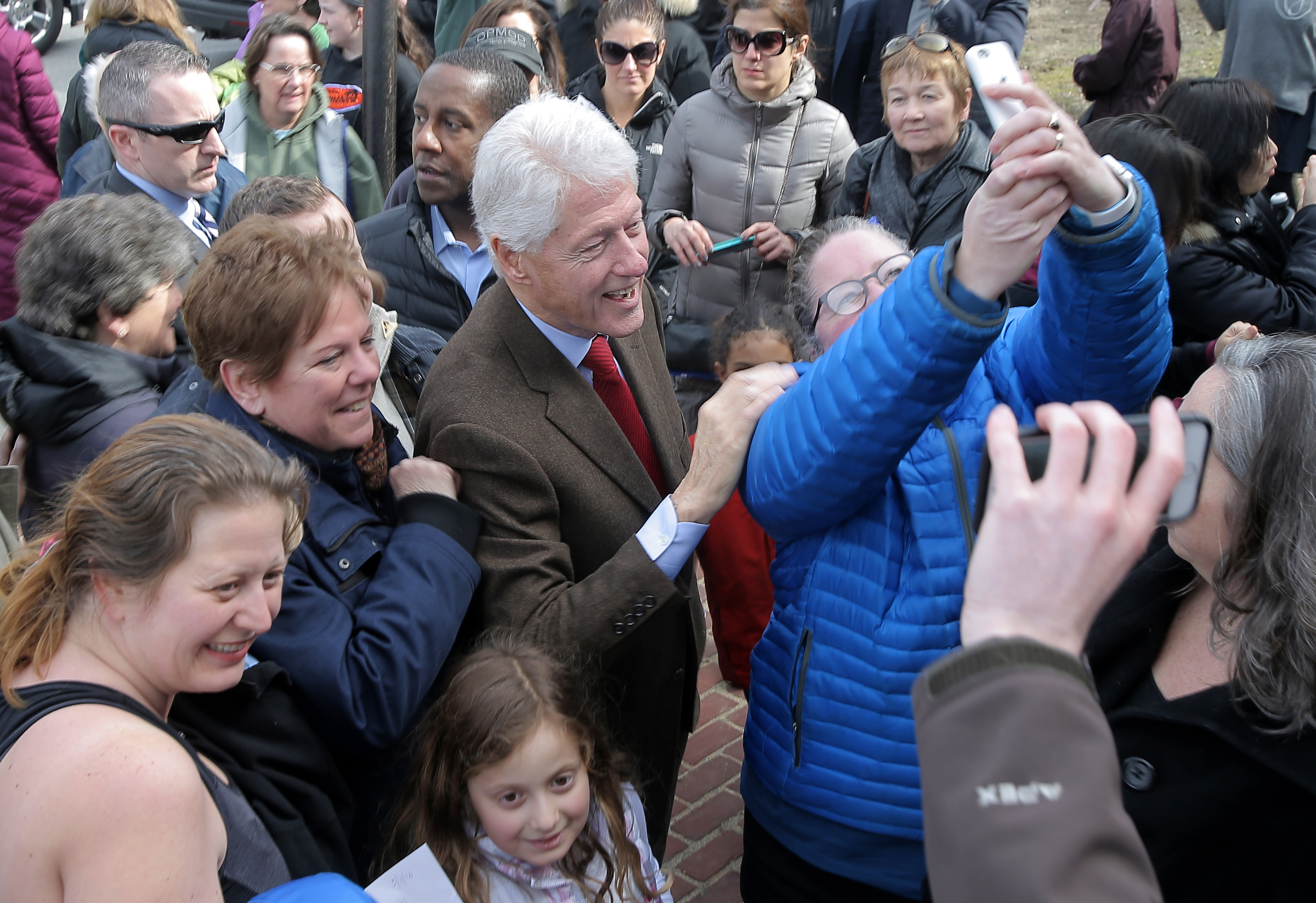 Bill Clinton posed with supporters in Newton.