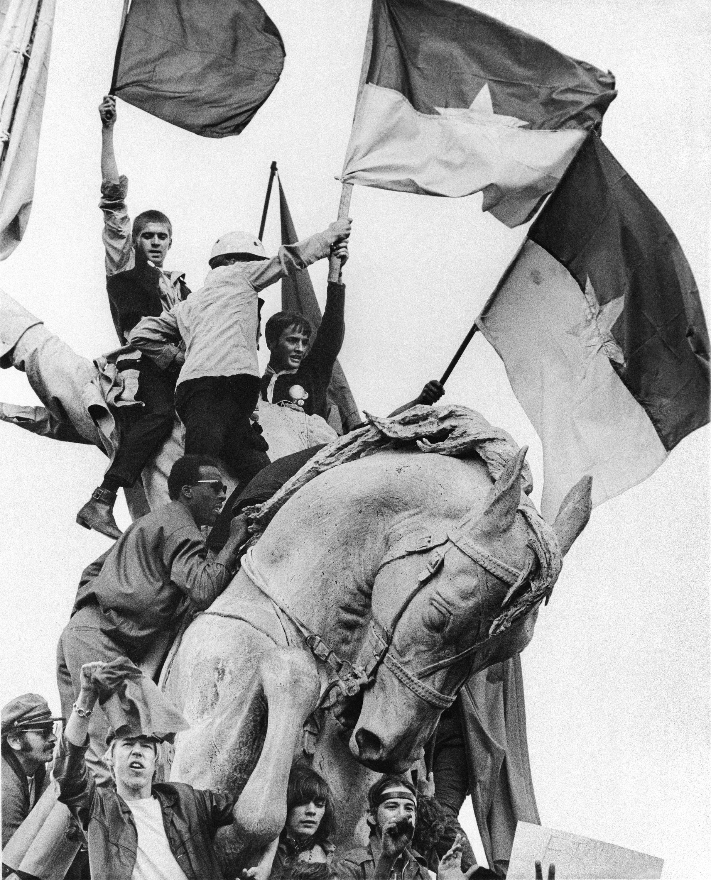 Protesters swarmed a statue of Civil War General John Logan in Chicago’s Grant Park.
