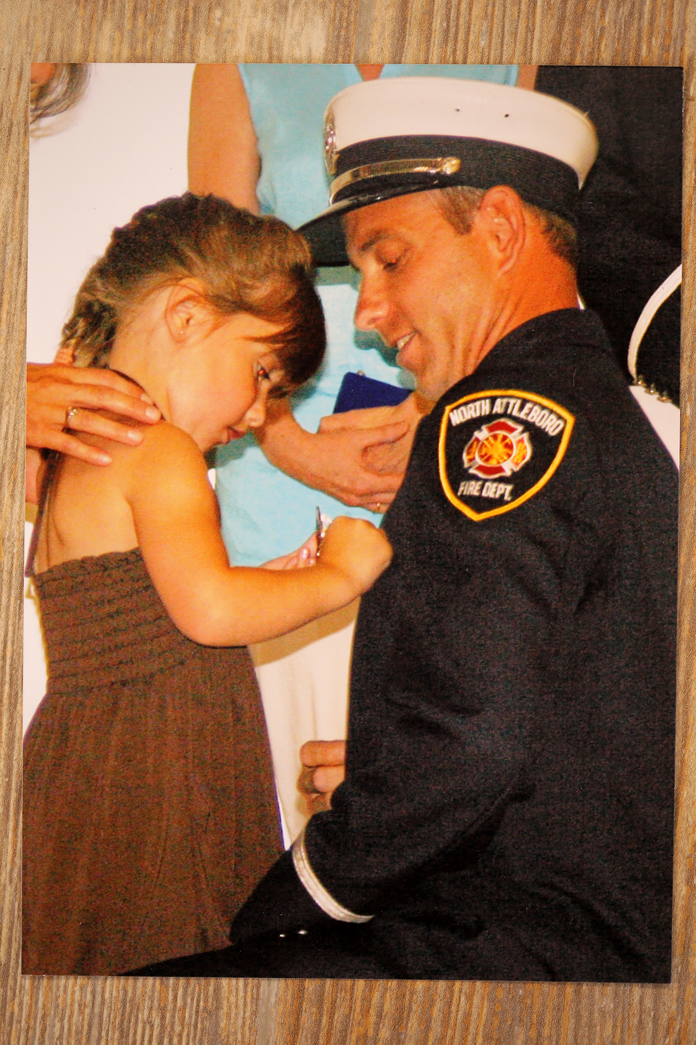A personal photo shows Captain Rick Stack getting pinned with his young daughter when he was promoted.