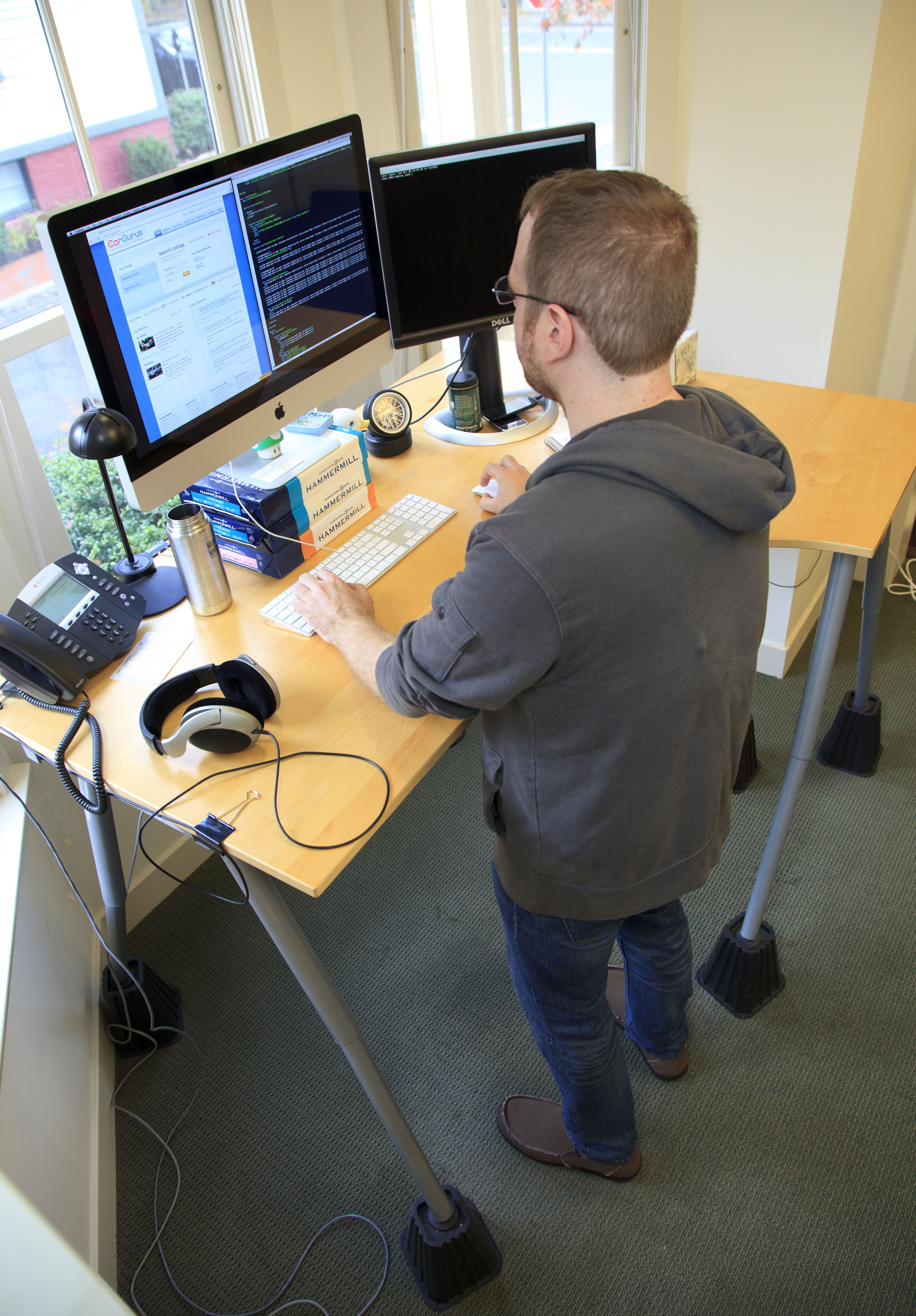 Jay Ciruolo works at his standing desk at CarGurus in Cambridge.