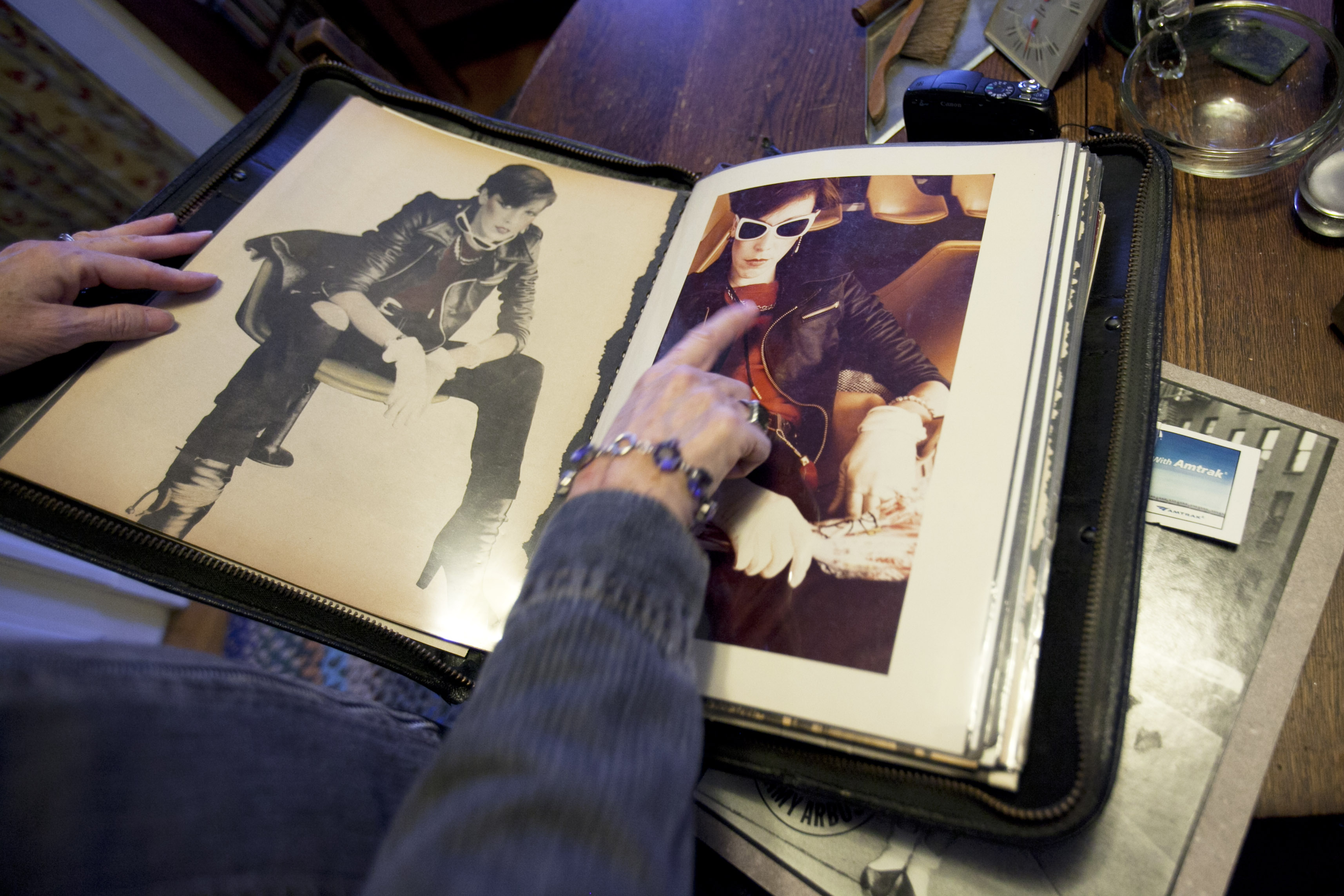 In her home, Jan Long Collins goes through her portfolio of images, some by Amy Arbus, some by other photographers.