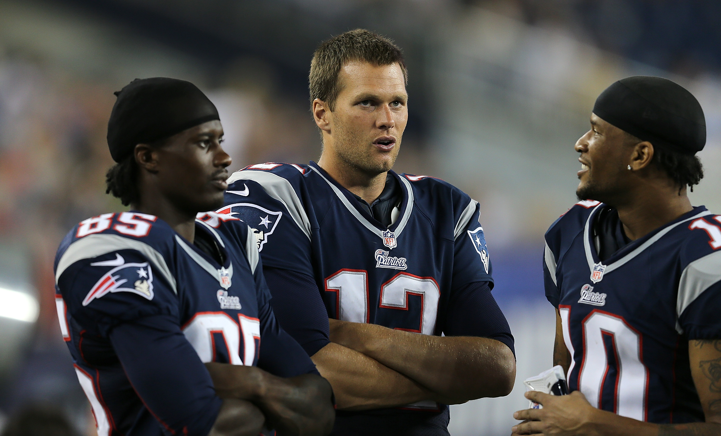 Brandon Lloyd (left), Tom Brady, and Jabar Gaffney chatted on the sideline during a preseason game against the New Orleans Saints at Gillette Stadium on August 9.