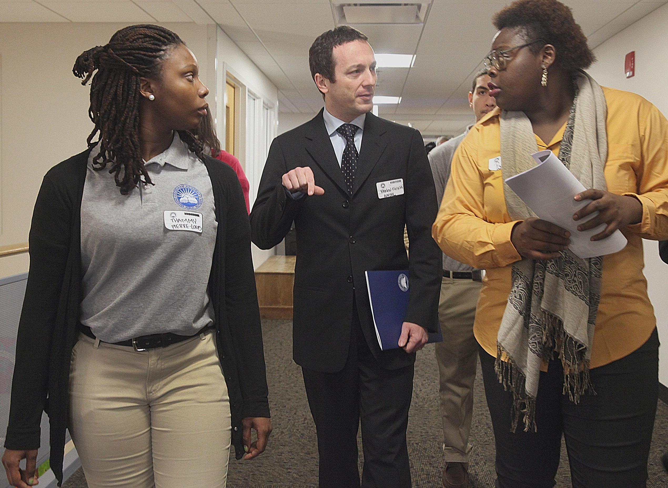 Thammy Pierre-Louis (left) and Porsha Olayiwola accompanied French Consul General Fabien Fieschi during a tour of Codman Academy in Dorchester on Wednesday.
