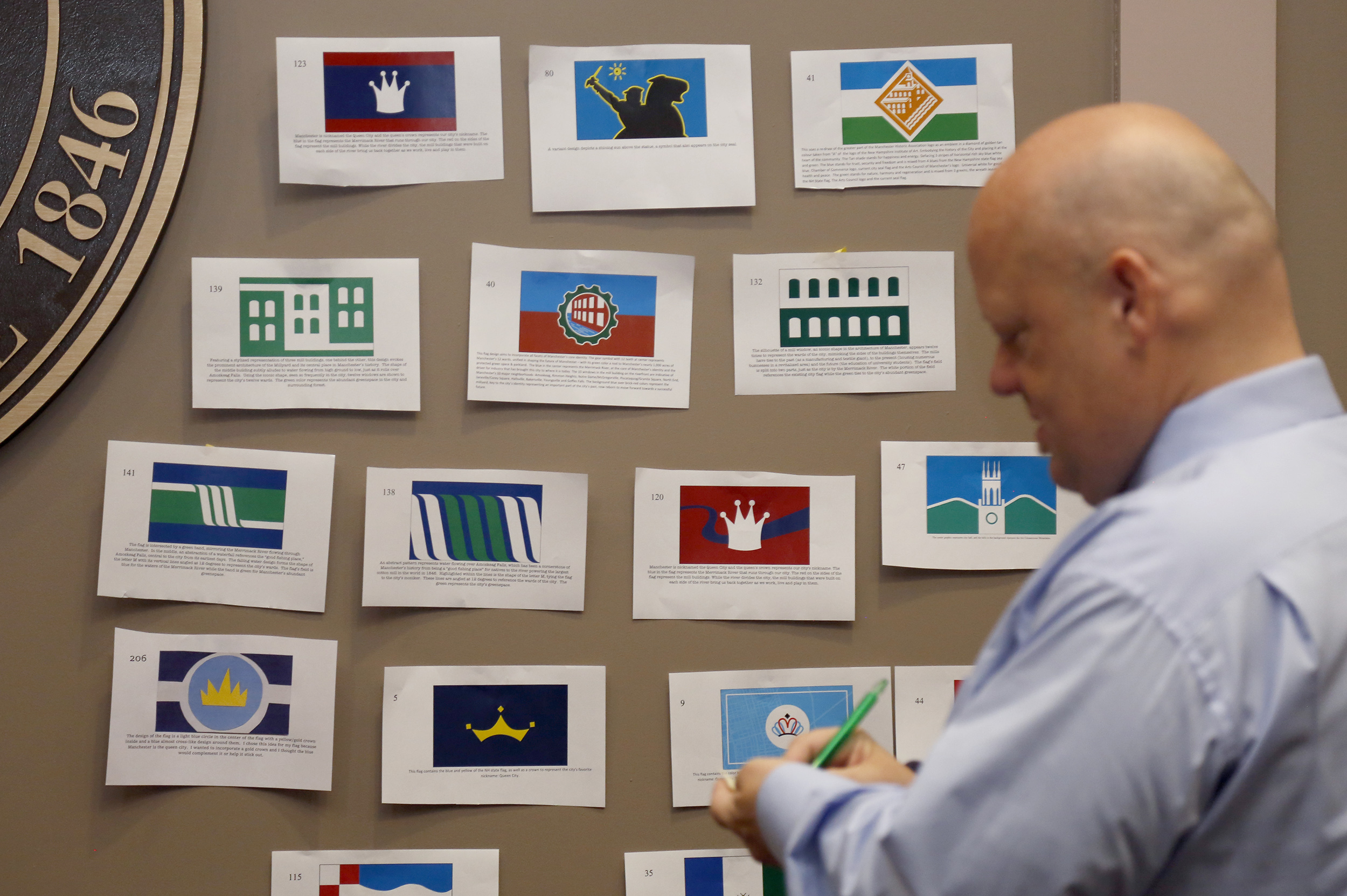 Berube took notes while reviewing the flag designs.