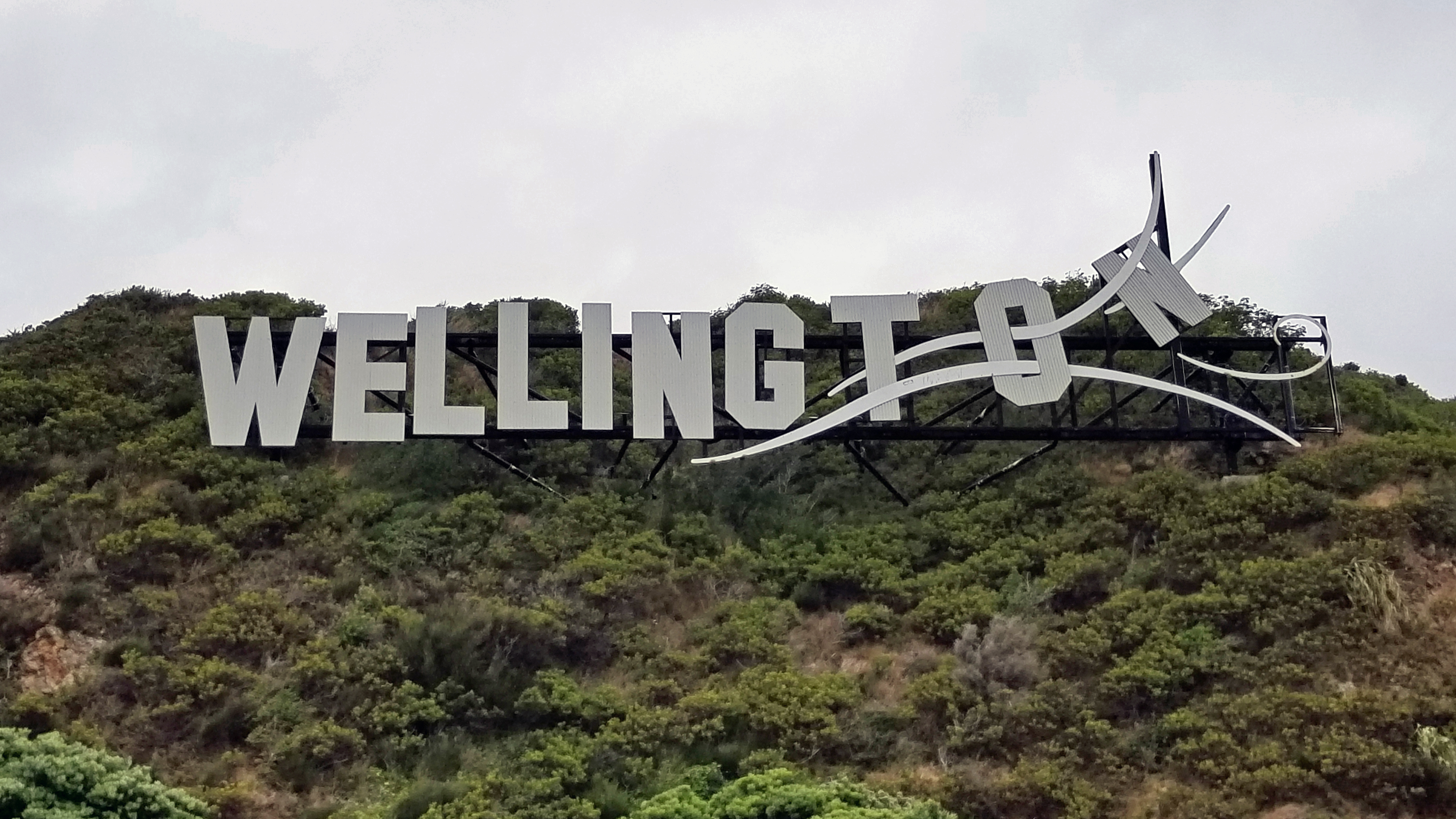 A sign near the airport references Wellington's nickname ("Windy Welly") and its reputation as the world's windiest city.