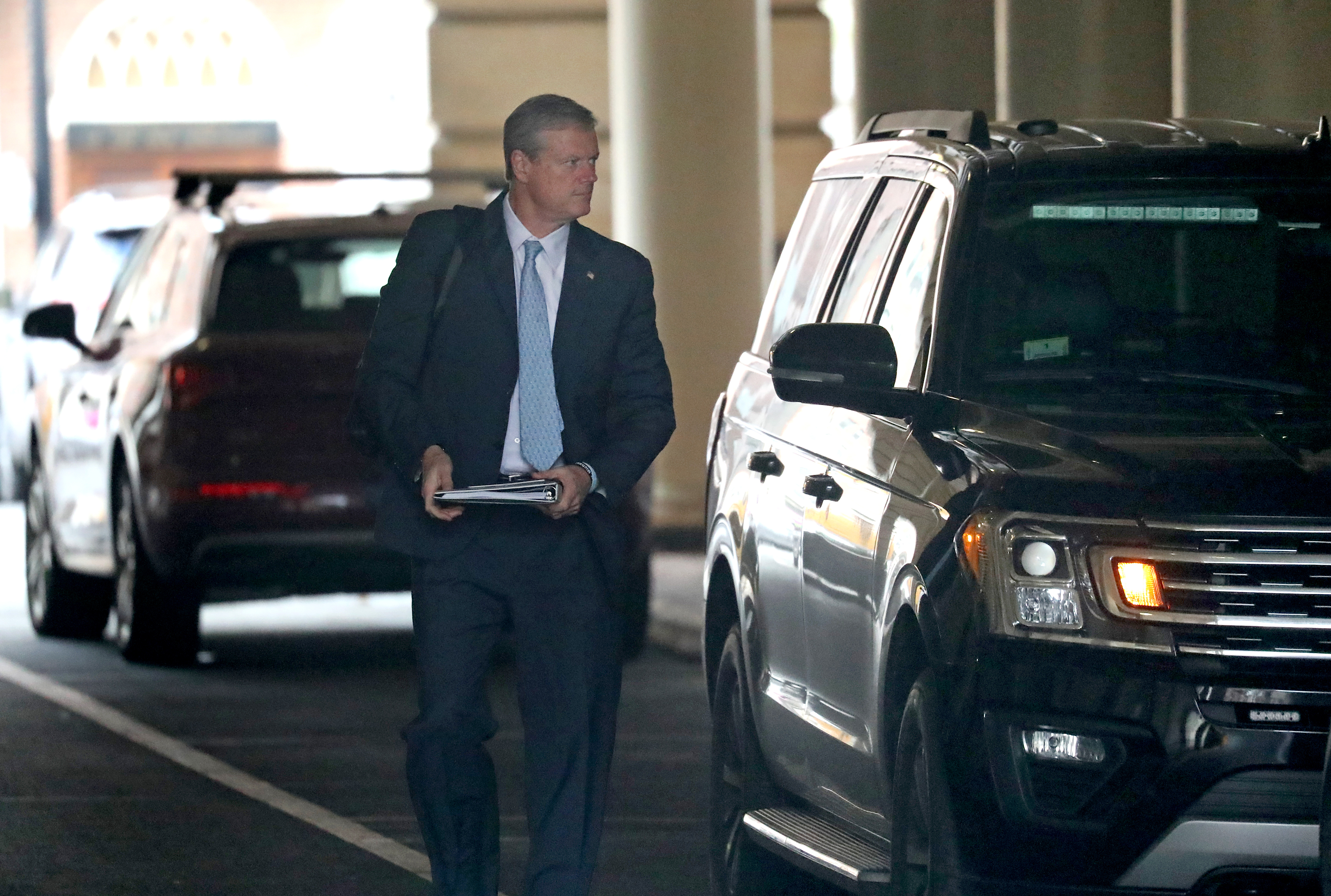 Govenor Charlie Baker arrives in the morning at the State House after being driven to work.