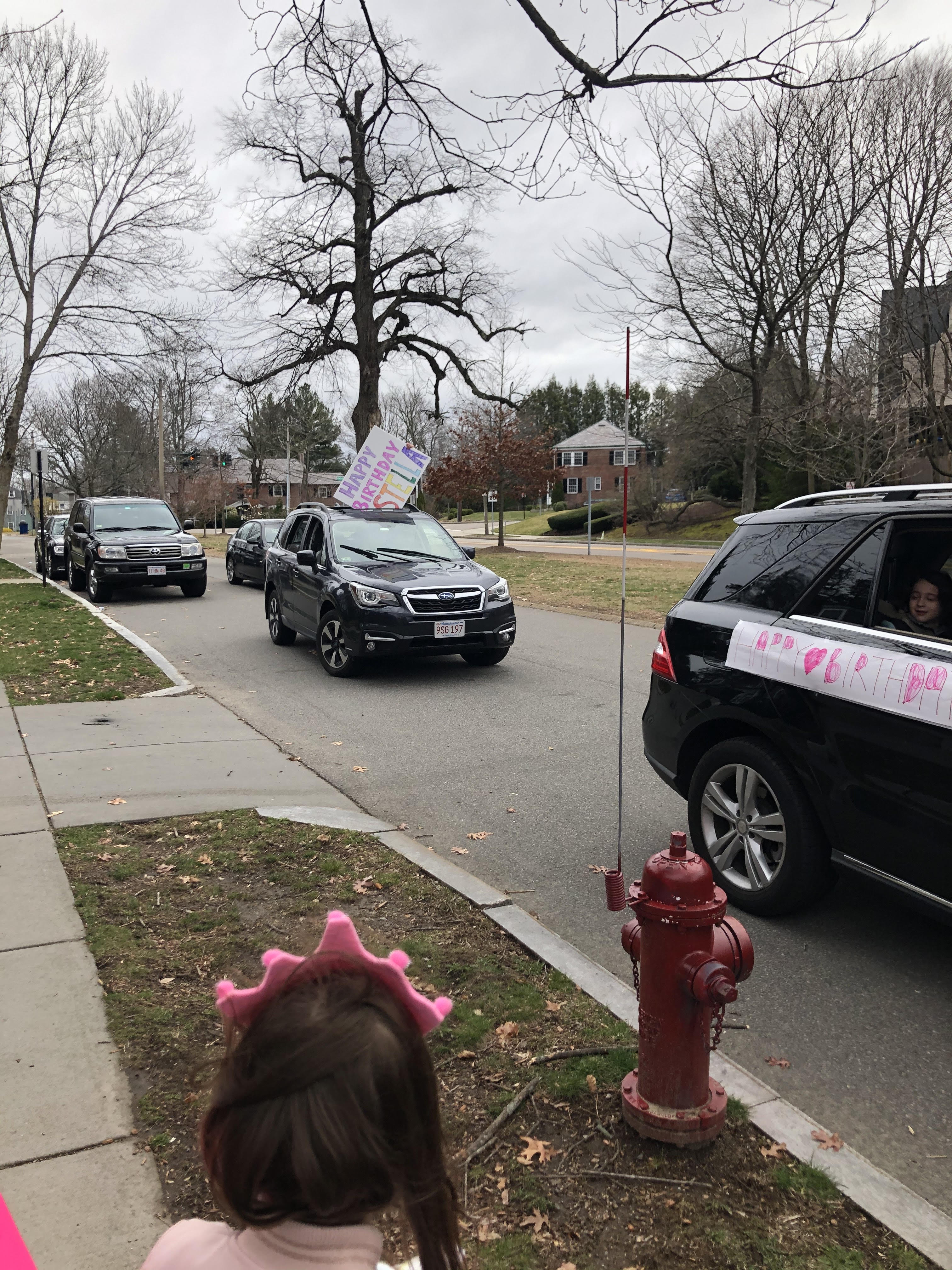 Six-year-old Stella Moran watched as friends drove by to wish her a happy birthday in Newton.
