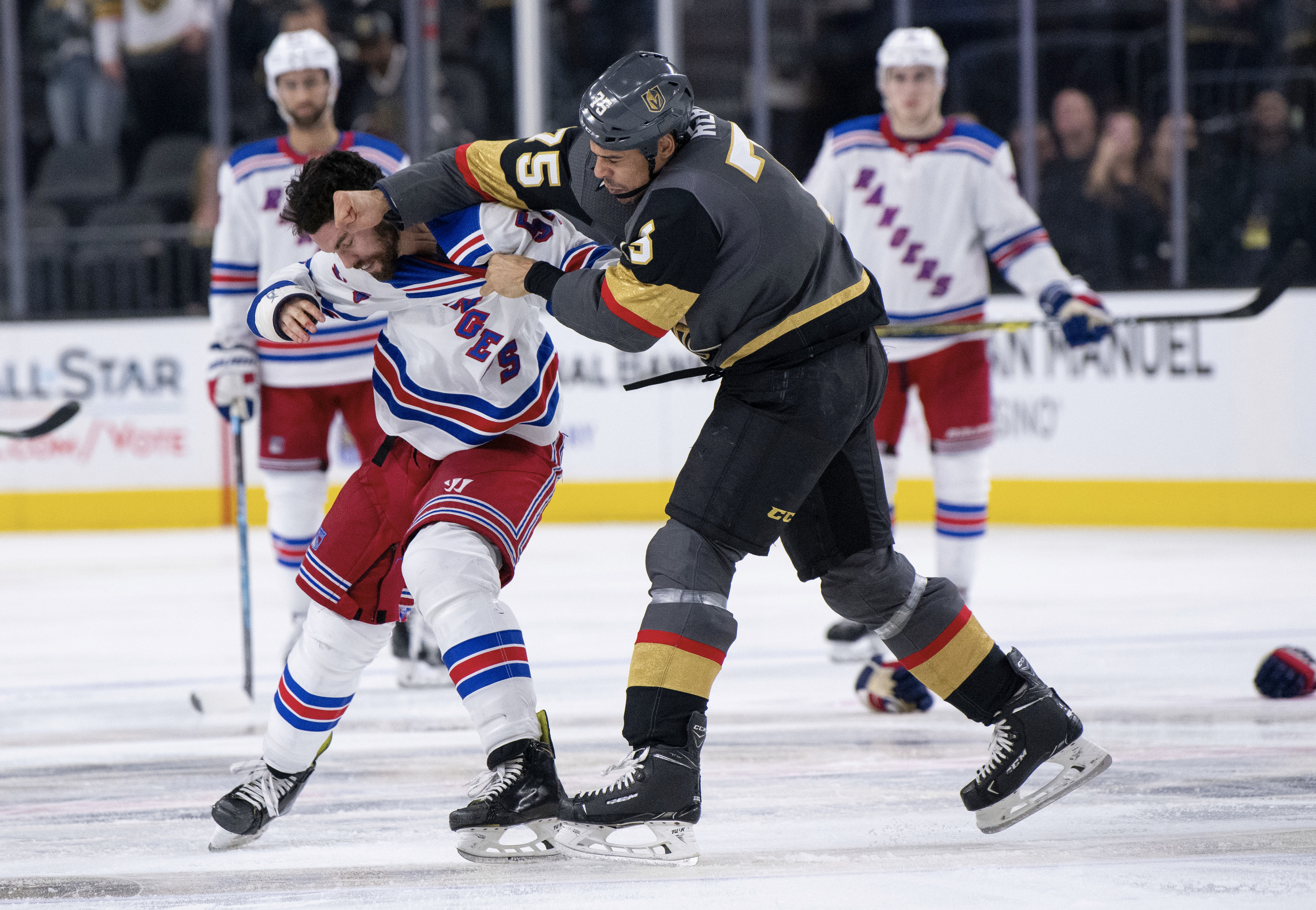 The Golden Knights’ Ryan Reaves, right, fights the Rangers’ Adam McQuaid during a game Tuesday.