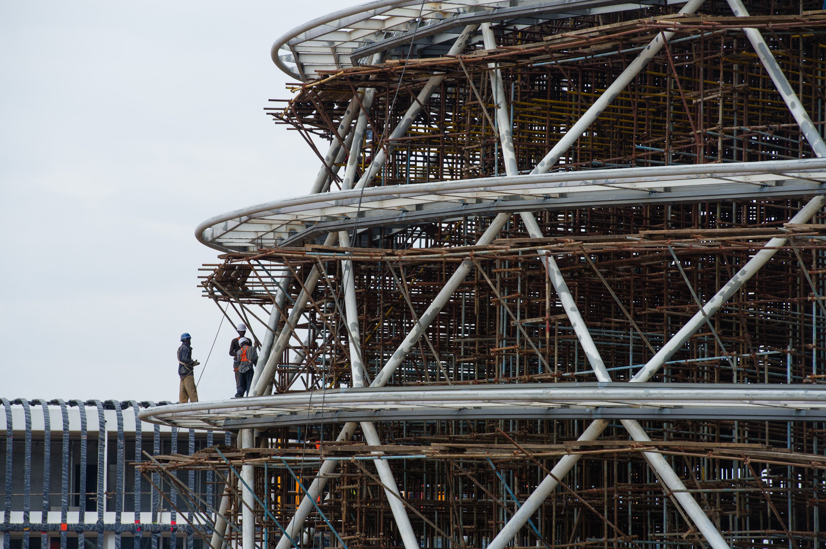 Workers walked the construction site of the Kigali Conference Centre on March 17. Rwanda’s economy has prompted a building boom.