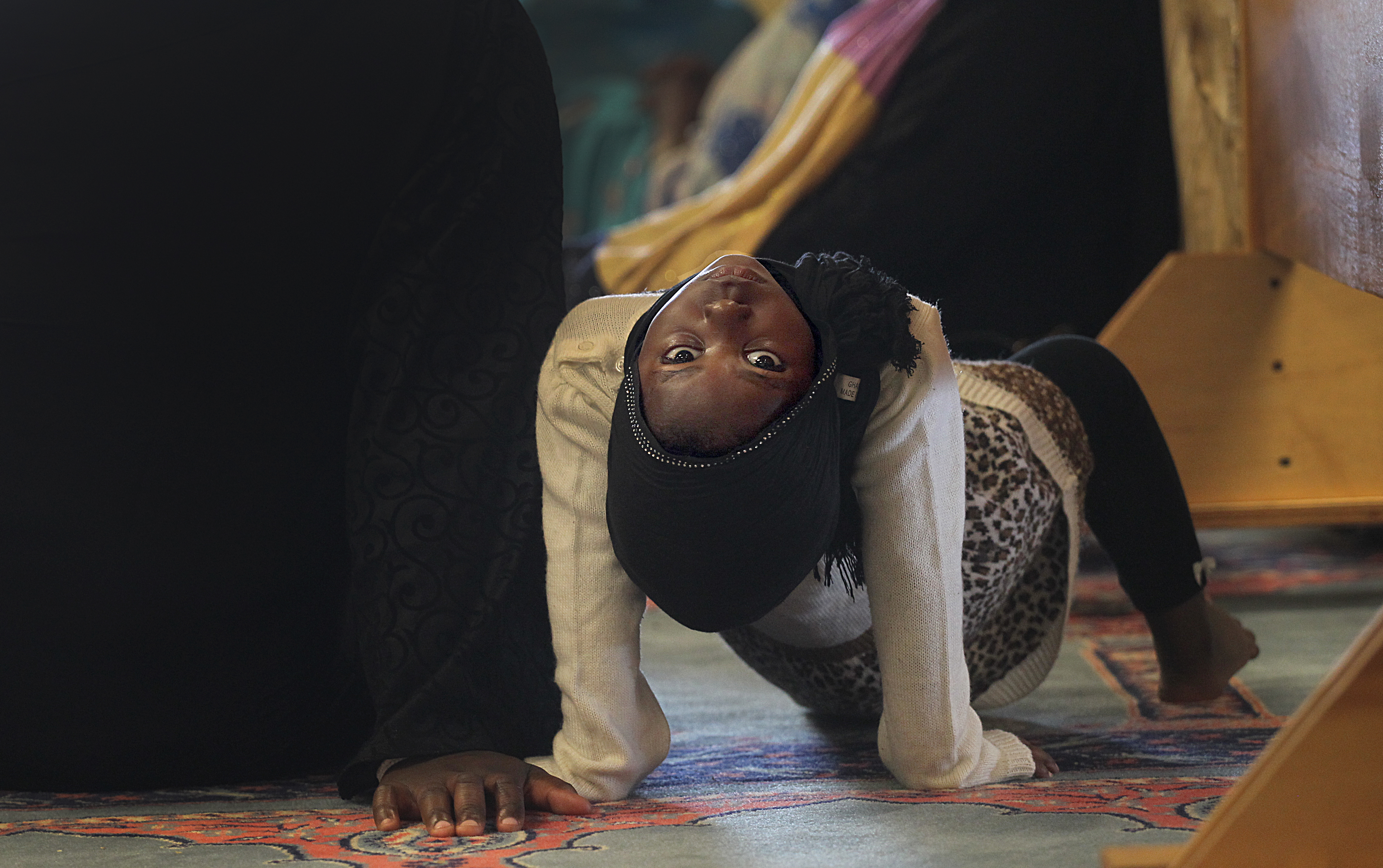 A girl played during the Friday prayers.