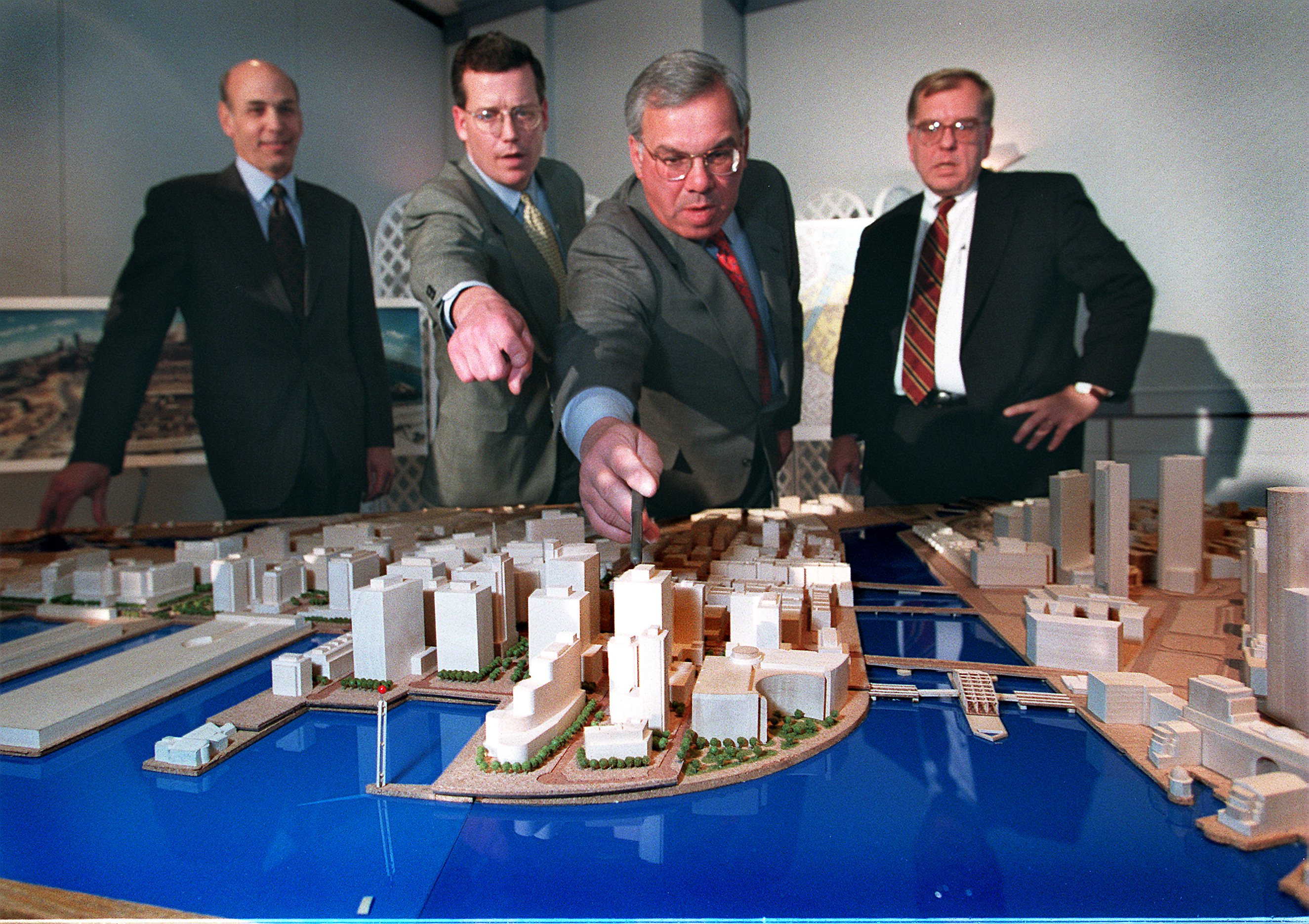 At a 1997 ceremony unveiling the South Boston Seaport Master Plan, Tom O’Brien (second from left) and Mayor Thomas M. Menino (third from left) pointed toward the newly-developed waterfront.